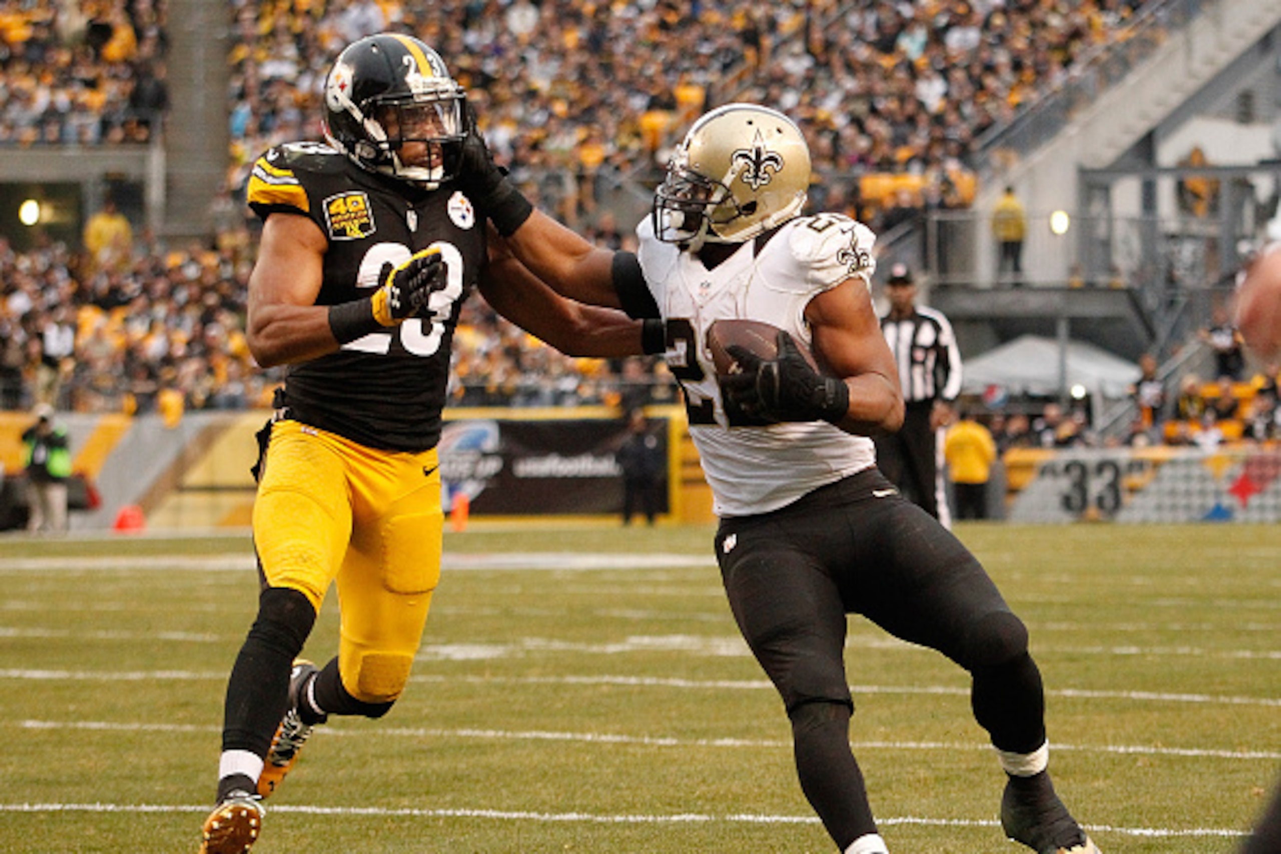 PITTSBURGH, PA - NOVEMBER 30:  Mark Ingram #22 of the New Orleans Saints stiff arms Mike Mitchell #23 of the Pittsburgh Steelers during the fourth quarter at Heinz Field on November 30, 2014 in Pittsburgh, Pennsylvania.  (Photo by Justin K. Aller/Getty Im