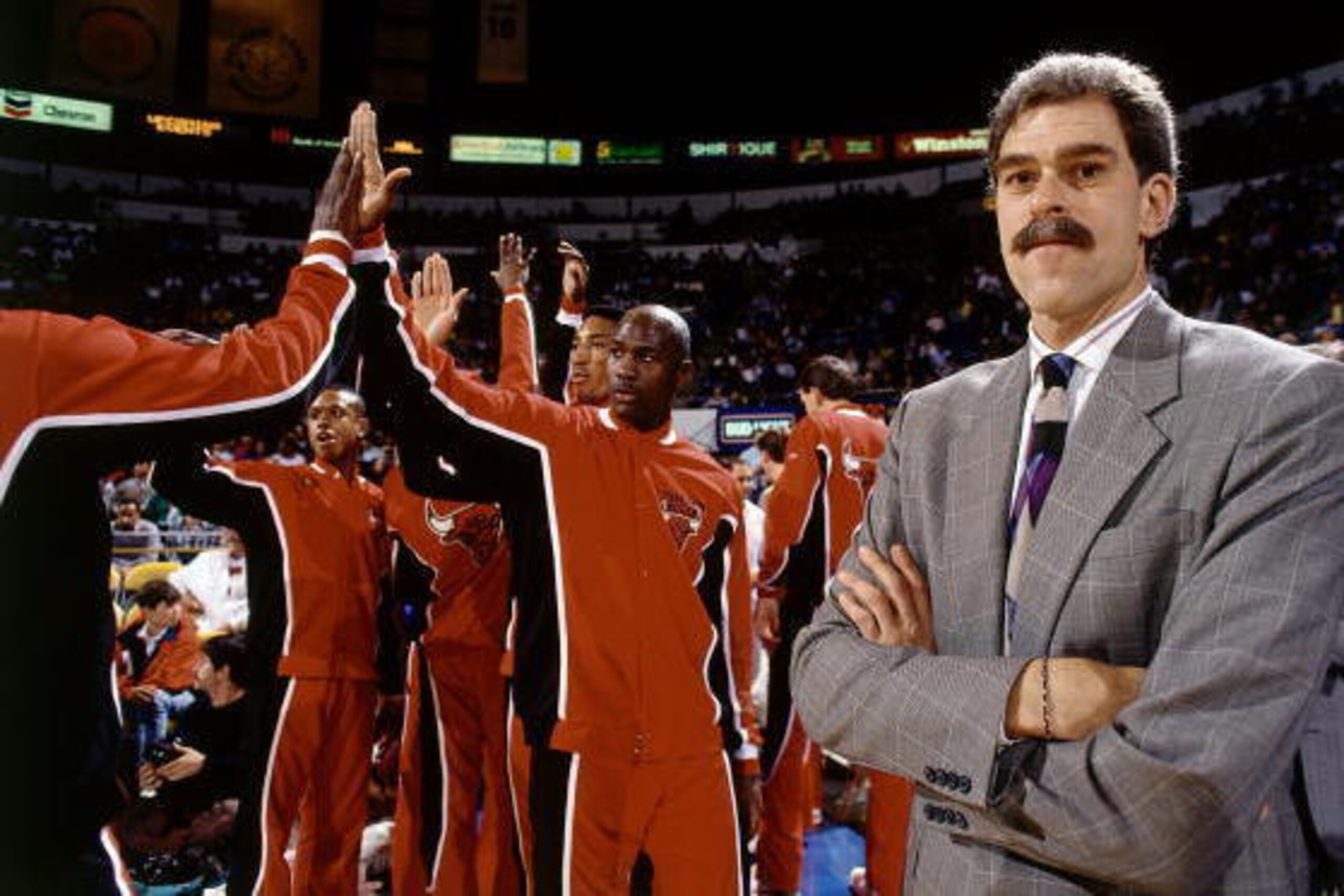 CHICAGO - 1990: Head Coach Phil Jackson of the Chicago Bulls looks on as Michael Jordan gets introduced prior to a game circa 1990 at the United Center in Chicago, Illinois. NOTE TO USER: User expressly acknowledges and agrees that, by downloading and/or CHICAGO - 1990: Head Coach Phil Jackson of the Chicago Bulls looks on as Michael Jordan gets introduced prior to a game circa 1990 at the United Center in Chicago, Illinois. NOTE TO USER: User expressly acknowledges and agrees that, by downloading and/or