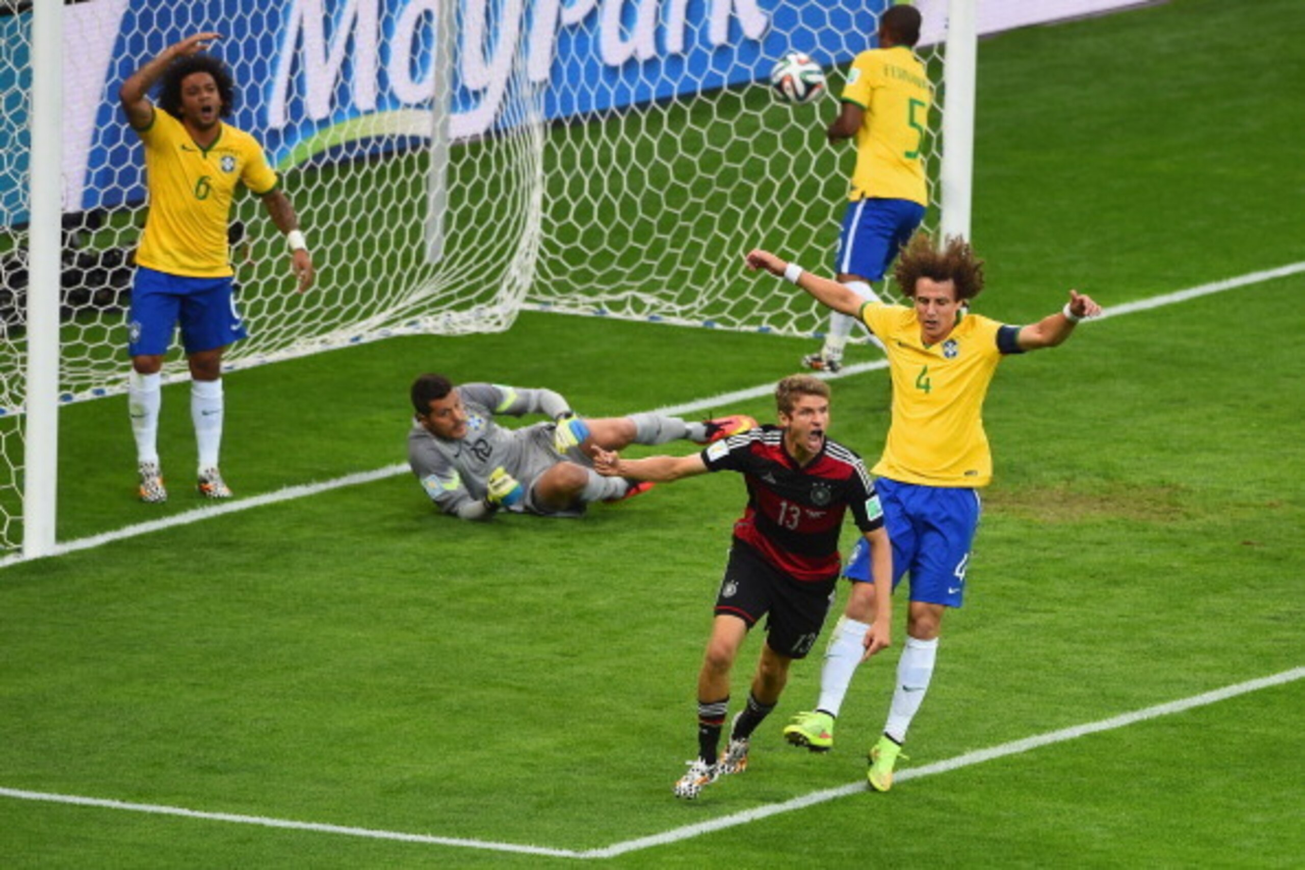 BELO HORIZONTE, BRAZIL - JULY 08:  Thomas Mueller of Germany celebrates scoring his team's first goal past Julio Cesar of Brazil during the 2014 FIFA World Cup Brazil Semi Final match between Brazil and Germany at Estadio Mineirao on July 8, 2014 in Belo 
