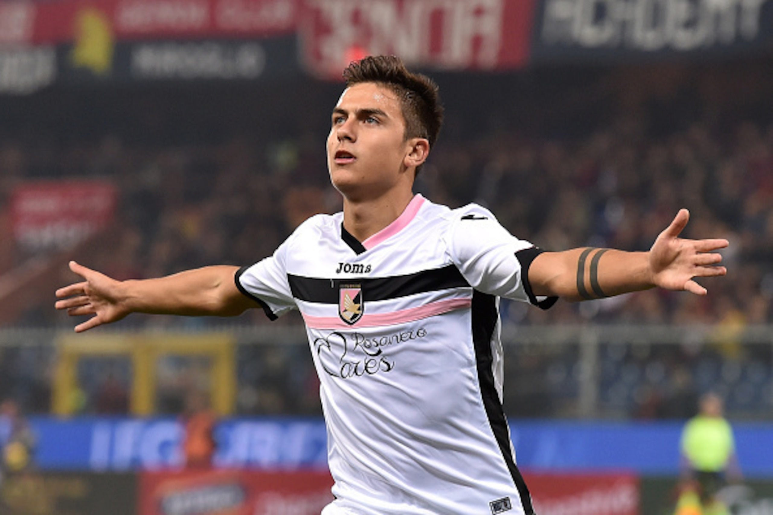 GENOA, ITALY - NOVEMBER 24: Paulo Dybala of US Citta di Palermo celebrates after scoring the opening goal during the Serie A match between Genoa CFC and US Citta di Palermo at Stadio Luigi Ferraris on November 24, 2014 in Genoa, Italy. (Photo by Valerio GENOA, ITALY - NOVEMBER 24: Paulo Dybala of US Citta di Palermo celebrates after scoring the opening goal during the Serie A match between Genoa CFC and US Citta di Palermo at Stadio Luigi Ferraris on November 24, 2014 in Genoa, Italy. (Photo by Valerio