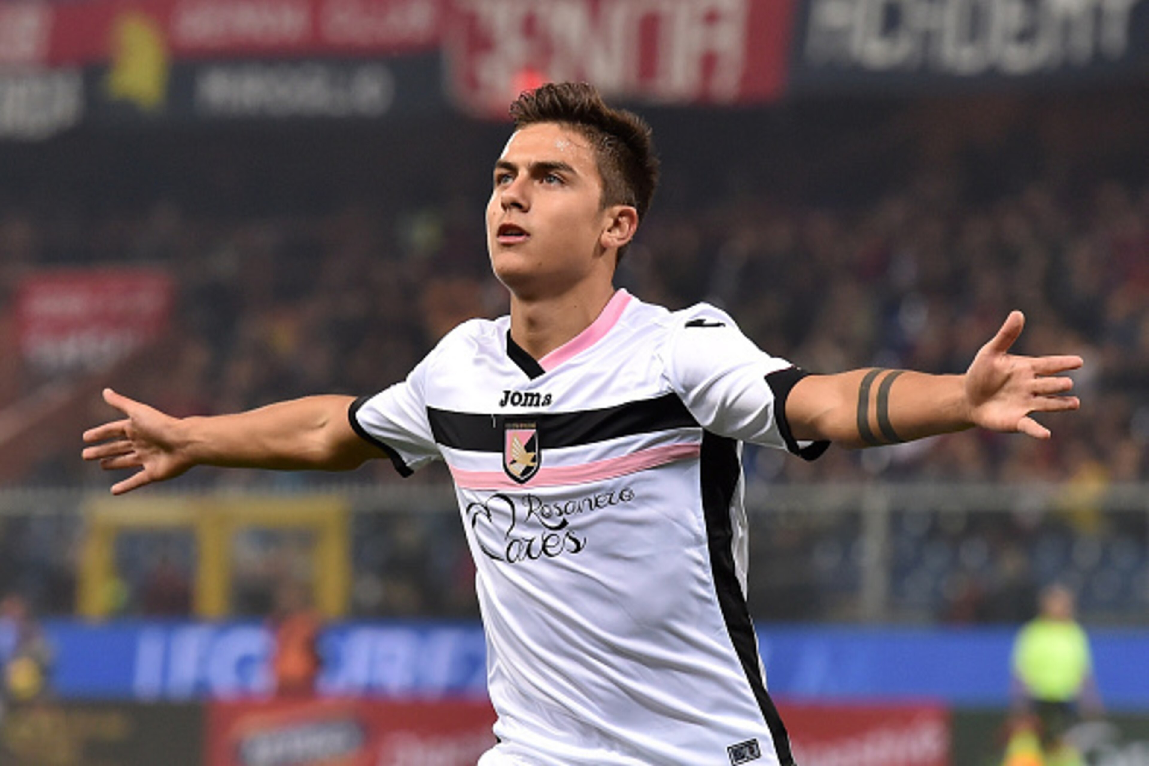GENOA, ITALY - NOVEMBER 24: Paulo Dybala of US Citta di Palermo celebrates after scoring the opening goal during the Serie A match between Genoa CFC and US Citta di Palermo at Stadio Luigi Ferraris on November 24, 2014 in Genoa, Italy. (Photo by Valerio GENOA, ITALY - NOVEMBER 24: Paulo Dybala of US Citta di Palermo celebrates after scoring the opening goal during the Serie A match between Genoa CFC and US Citta di Palermo at Stadio Luigi Ferraris on November 24, 2014 in Genoa, Italy. (Photo by Valerio