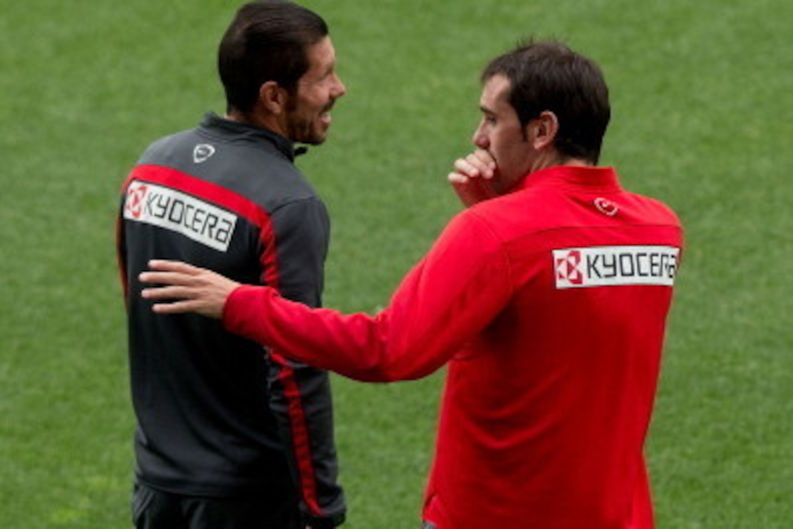 MADRID, SPAIN - MAY 19: Diego Godin (R) of Atletico de Madrid jokes with head coach Diego Pablo Simeone (L) during the training session held on the Media Day prior to UEFA Champions League Final between Club Atletico de Madrid and Real Madrid CF at Vicent