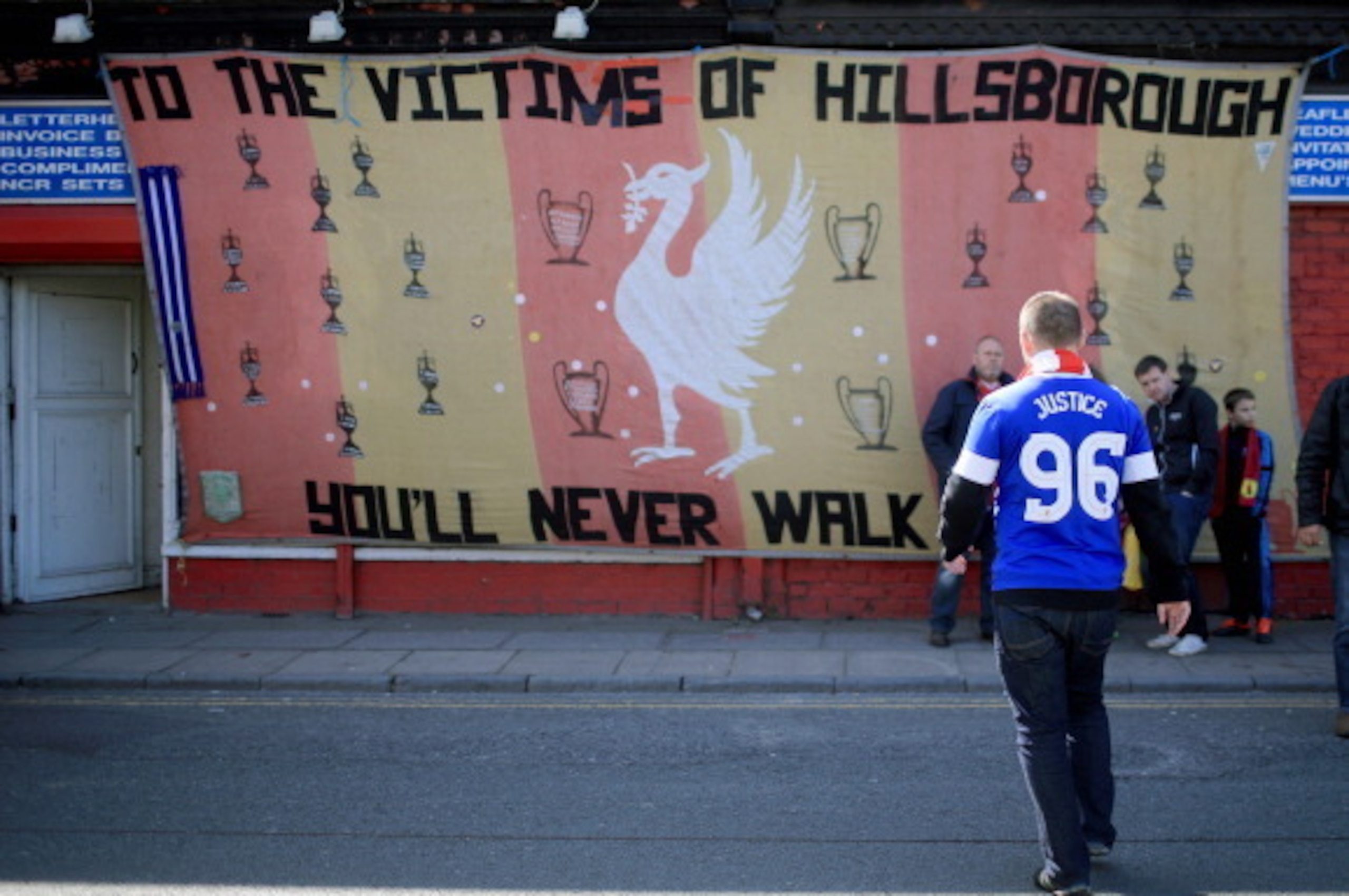 LIVERPOOL, ENGLAND - APRIL 15:  An Everton fan arrives in Anfield for a memorial service marking the 25th anniversary of the Hillsborough Disaster at Anfield stadium on April 15, 2014 in Liverpool, England. Thousands of fans, friends and relatives are att