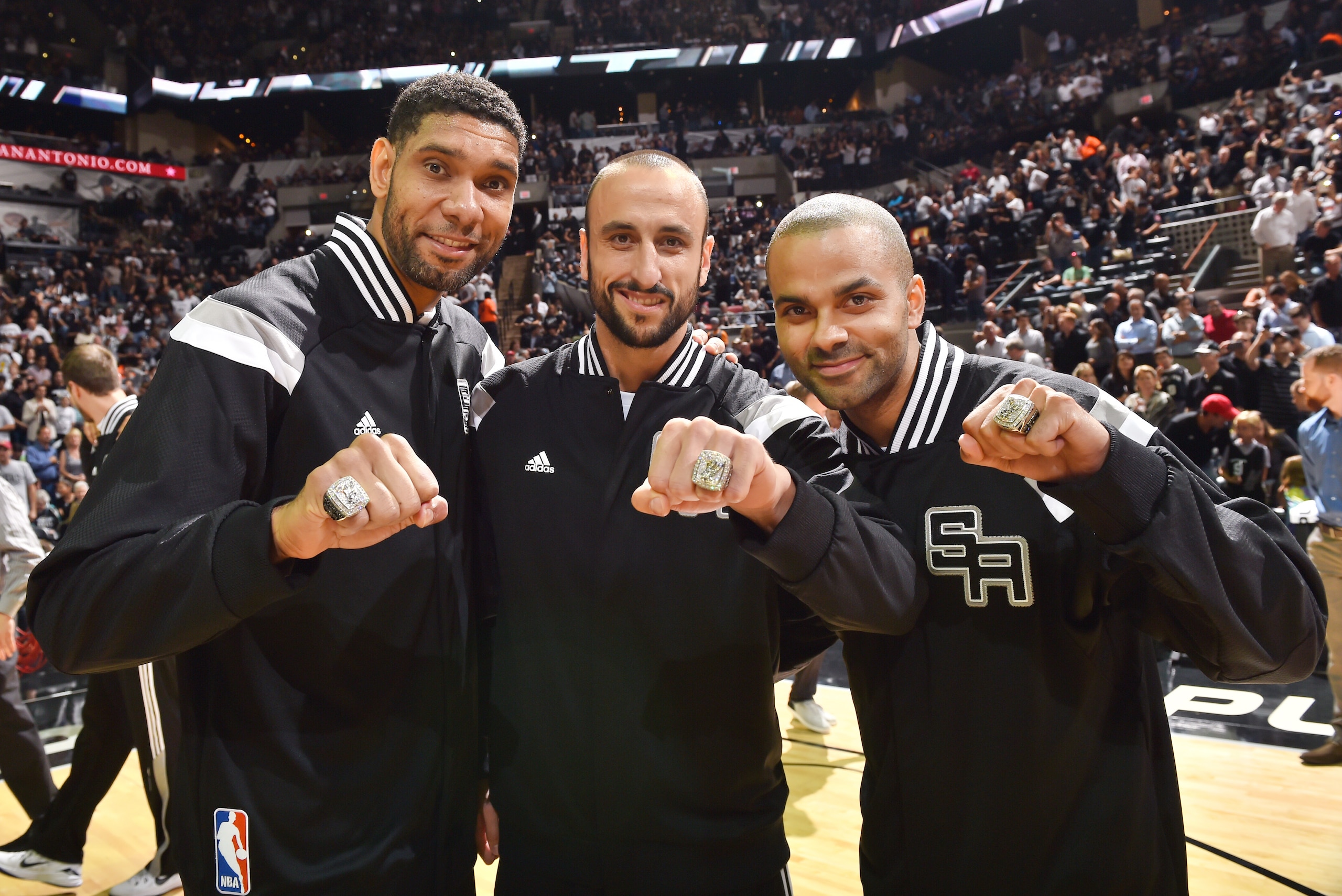 SAN ANTONIO, TX - OCTOBER 28: Tim Duncan #21, Marco Belinelli #3 and Tony Parker #9 of the San Antonio Spurs present their championship rings before the game against Dallas Mavericks on October 28, 2014 at the AT&T Center in San Antonio,Texas. NOTE TO USE