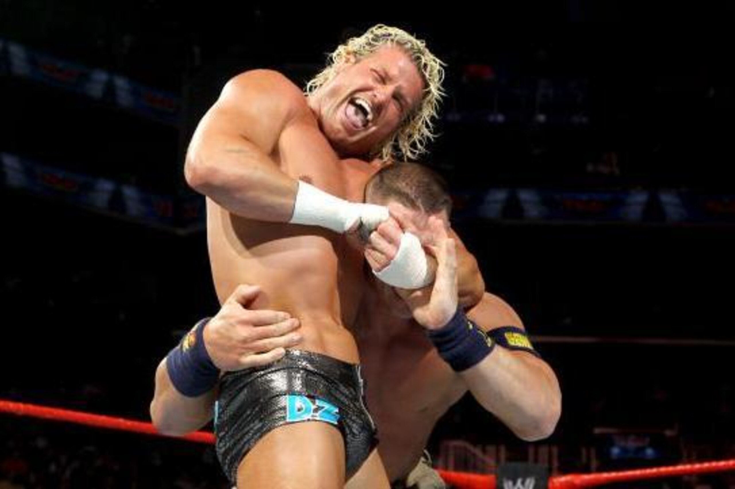 Dolph Ziggler clamps a headlock on John Cena.