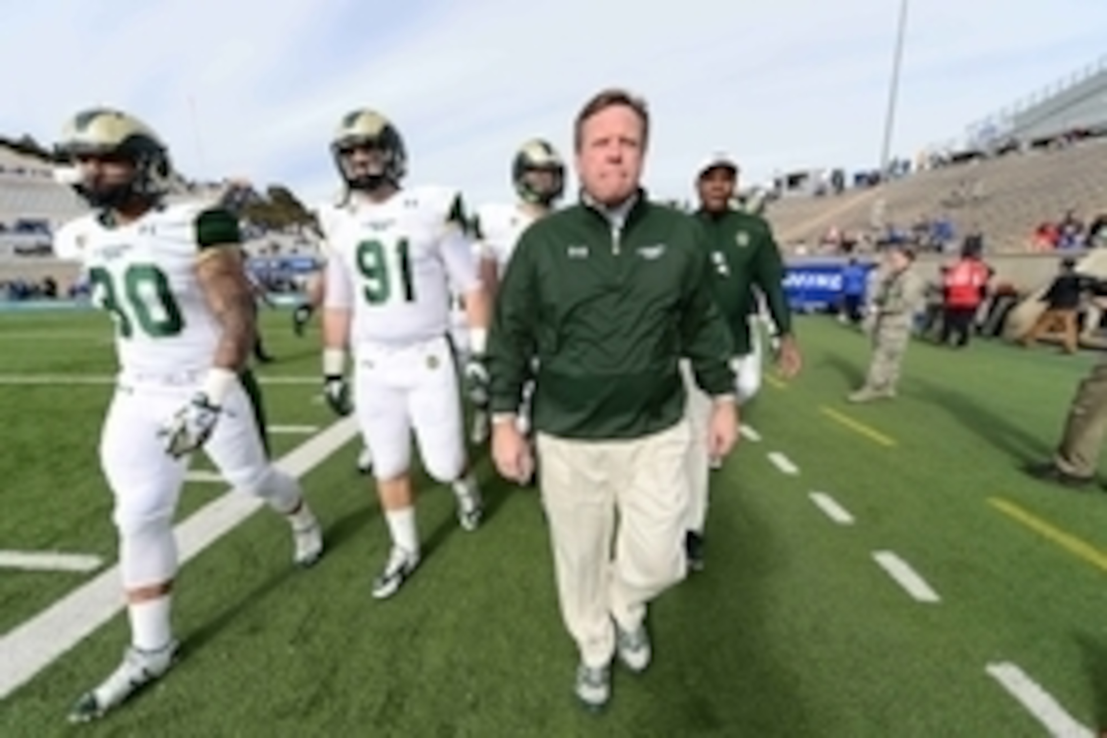 Nov 28, 2014; Colorado Springs, CO, USA; Colorado State Rams head coach Jim McElwain walks out onto Falcon Stadium with tight end Steven Walker (30) and defensive lineman Jakob Buys (91) before the start of the game against the Air Force Falcons. Mandator