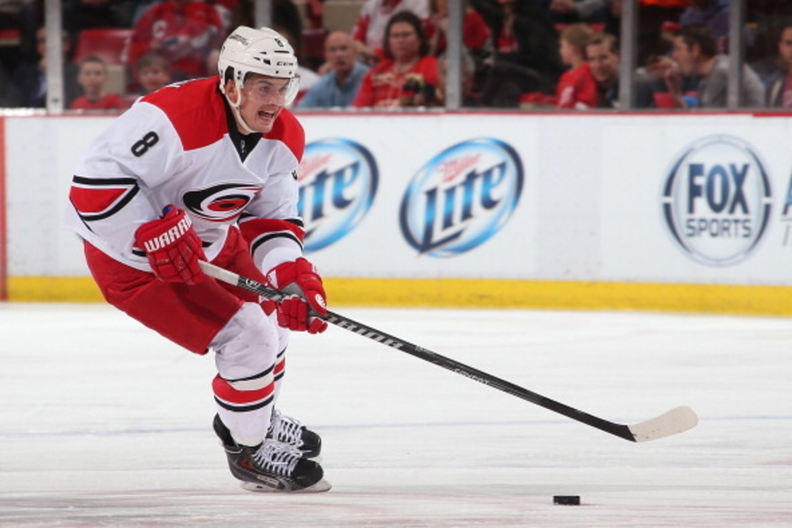 DETROIT, MI - APRIL 11: Andrei Loktionov #8 of the Carolina Hurricanes skates up ice with the puck against the Detroit Red Wings during an NHL game on April 11, 2014 at Joe Louis Arena in Detroit, Michigan. Carolina defeated Detroit 2-1 (Photo by Dave Reg