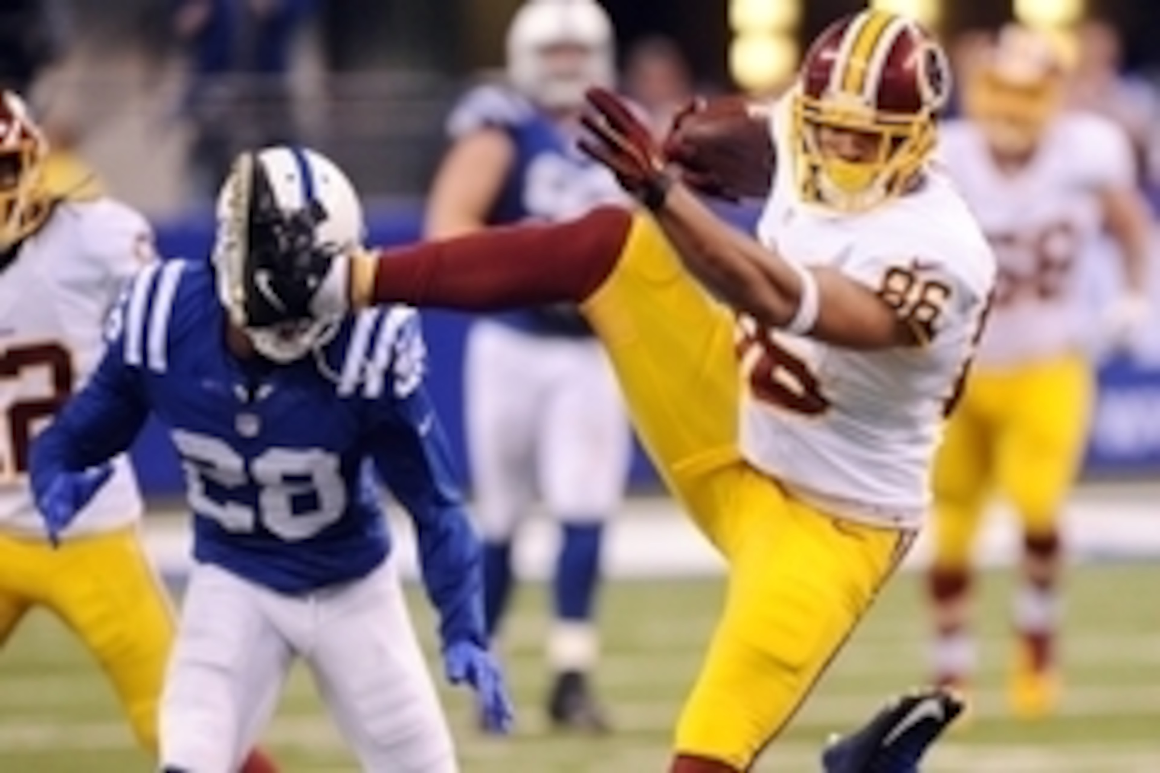 Nov 30, 2014; Indianapolis, IN, USA; Washington Redskins tight end Jordan Reed (86) tries to evade Indianapolis Colts safety Mike Adams (29) at Lucas Oil Stadium. The Colts won, 49-27. Mandatory Credit: Thomas J. Russo-USA TODAY Sports