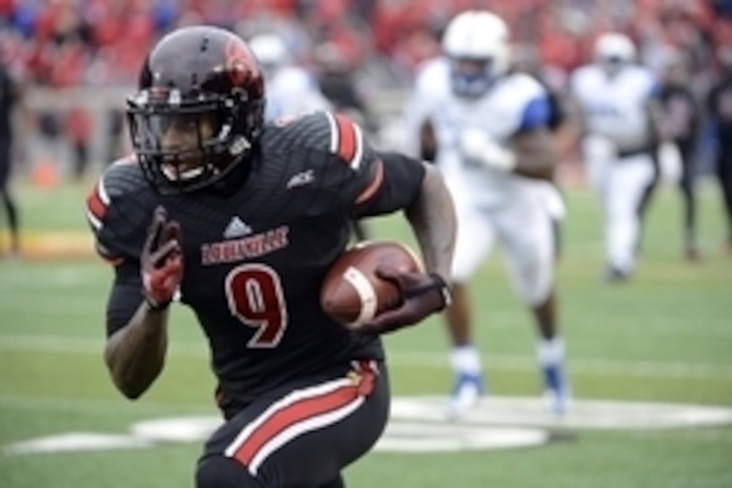 Nov 29, 2014; Louisville, KY, USA; Louisville Cardinals wide receiver DeVante Parker (9) runs the ball against the Kentucky Wildcats during the second half at Papa John's Cardinal Stadium. Louisville defeated Kentucky 44-40.  Mandatory Credit: Jamie Rhode