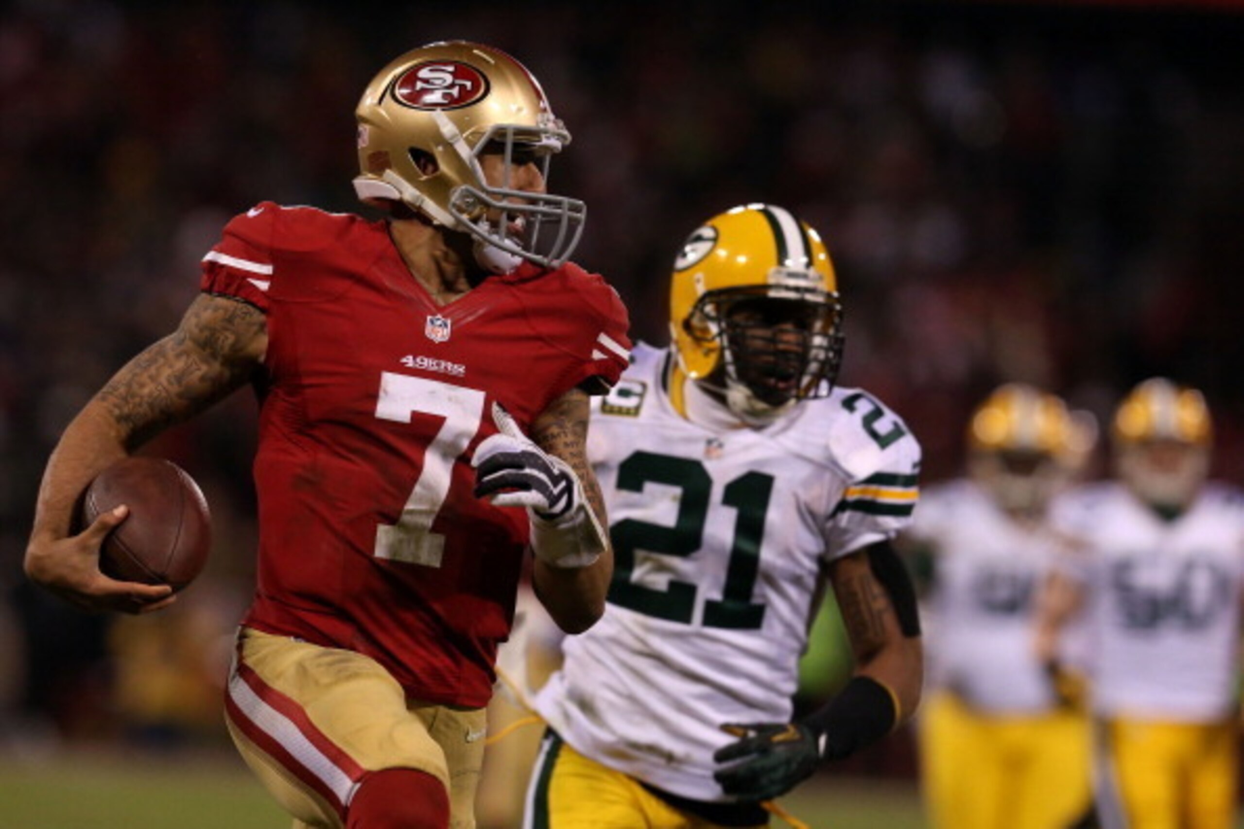 SAN FRANCISCO, CA - JANUARY 12:  Quarterback Colin Kaepernick #7 of the San Francisco 49ers runs the ball against strong safety Charles Woodson #21 of the Green Bay Packers during the NFC Divisional Playoff Game at Candlestick Park on January 12, 2013 in 