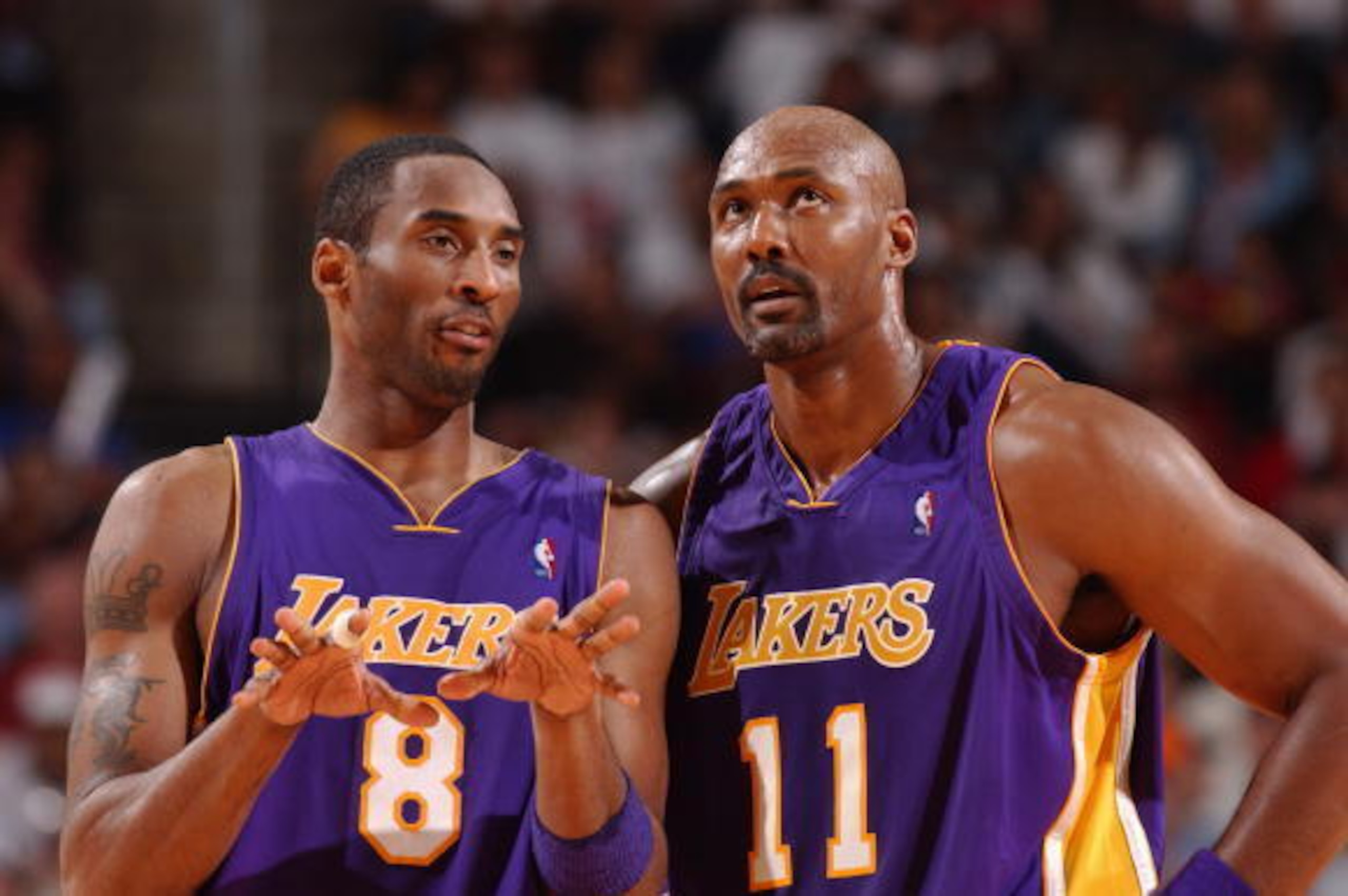 HOUSTON - APRIL 25:  Kobe Bryant #8 of the Los Angeles Lakers talks to his teammate Karl Malone #11 in Game four of The Western Conference Quarterfinals during the 2004 NBA Playoffs at Toyota Center on April 25, 2004 in Houston, Texas.  The Lakers won 92-