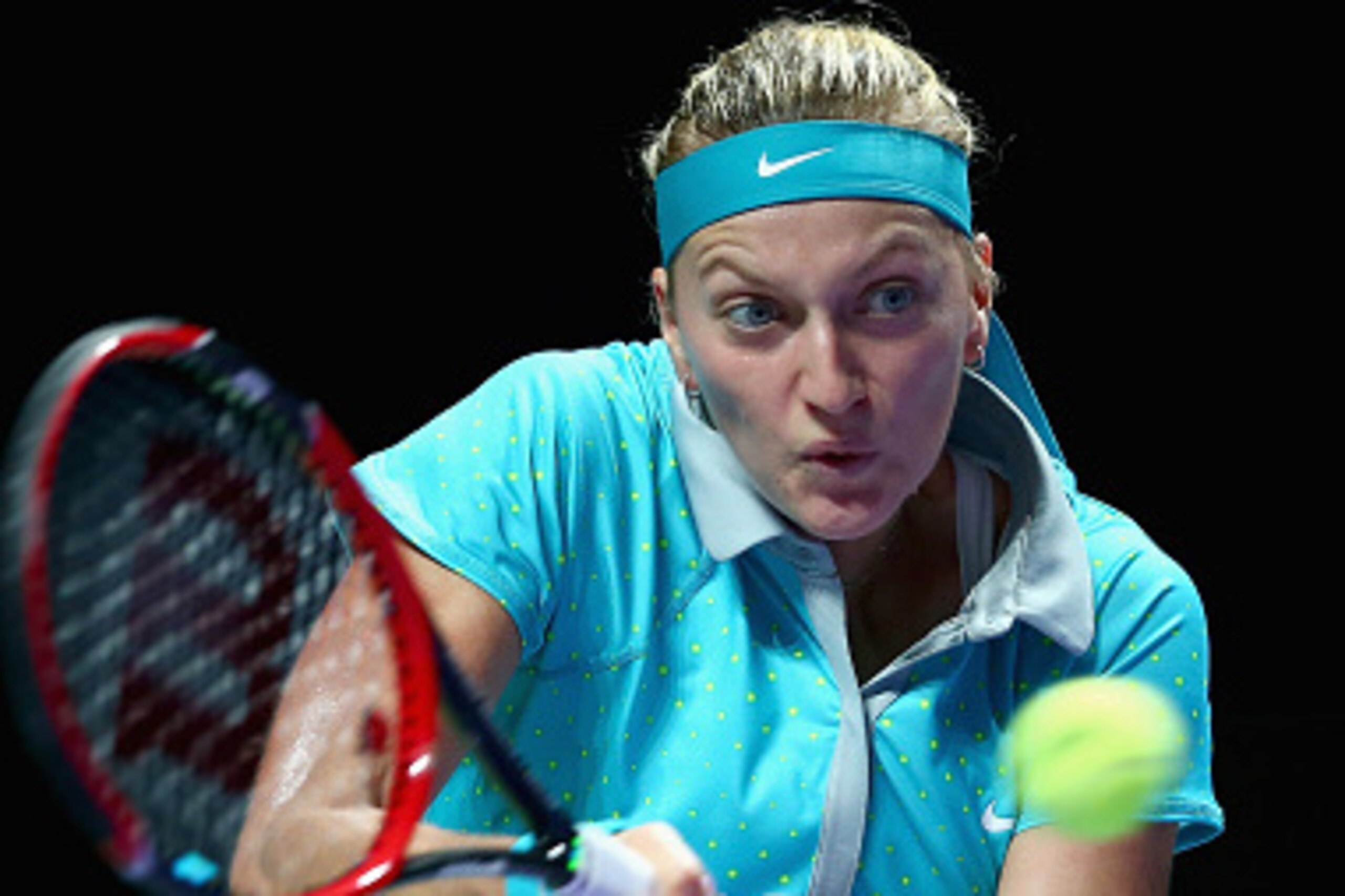 SINGAPORE - OCTOBER 24:  Petra Kvitova of the Czech Republic plays a forehand against Caroline Wozniacki of Denmark in their round robin match during the BNP Paribas WTA Finals at Singapore Sports Hub on October 24, 2014 in Singapore.  (Photo by Clive Bru