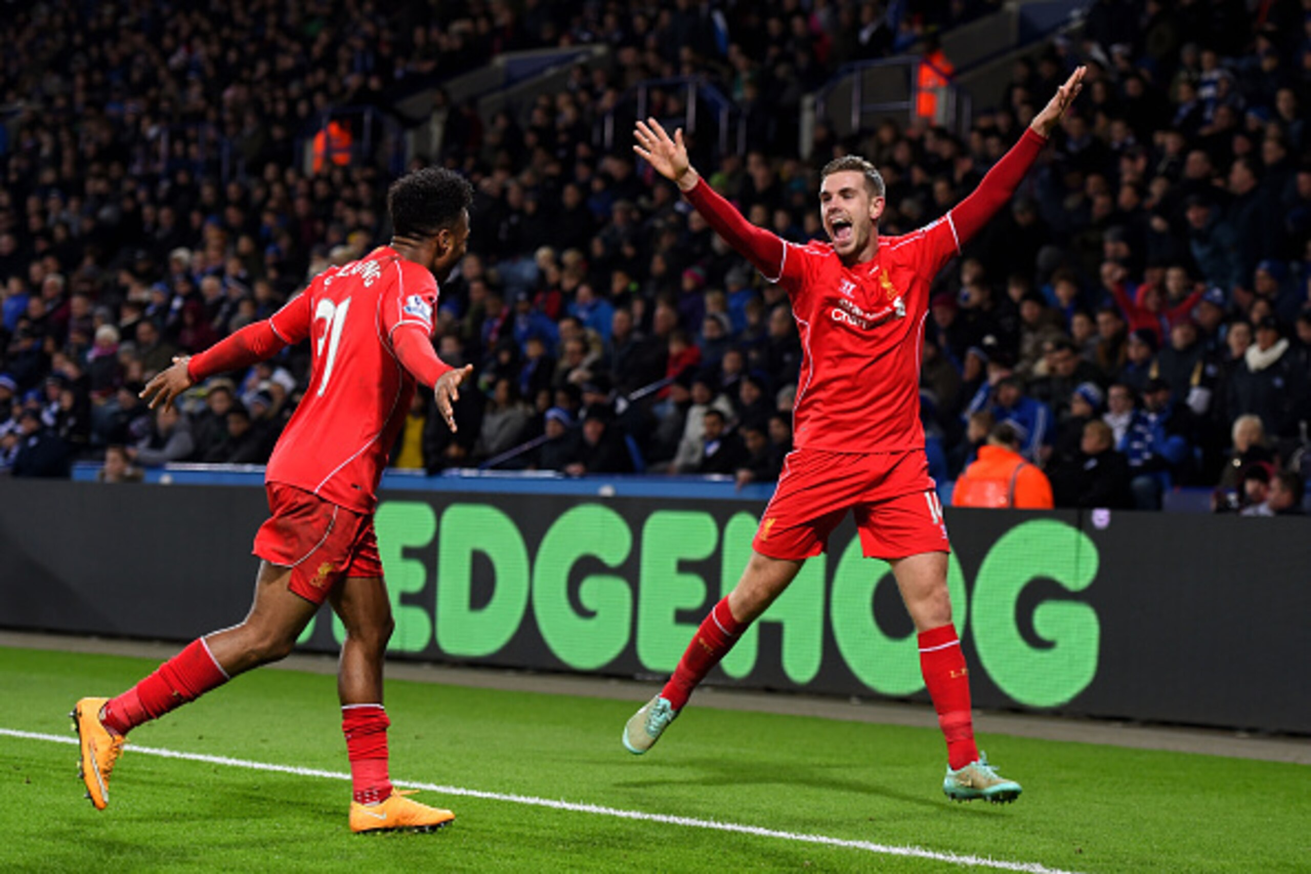 LEICESTER, ENGLAND - DECEMBER 02:  Jordan Henderson (R) of Liverpool celebrates with teammate Raheem Sterling of Liverpool after scoring his team's third goal during the Barclays Premier League match between Leicester City and Liverpool at The King Power 