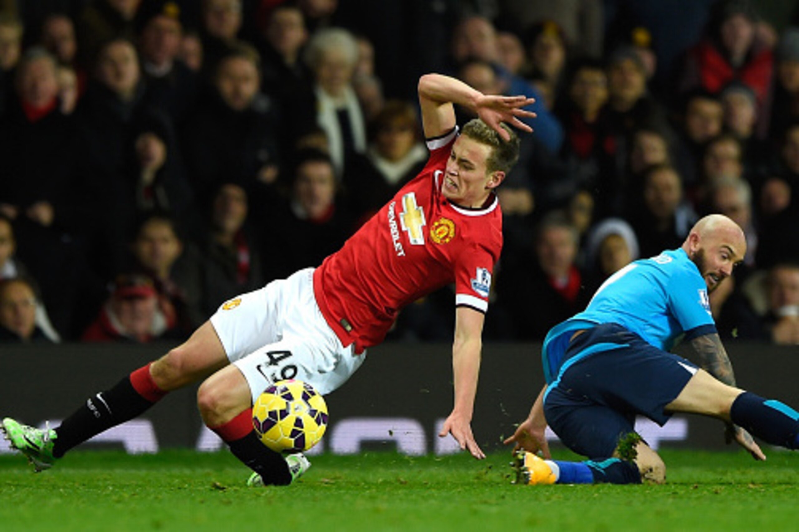 MANCHESTER, ENGLAND - DECEMBER 02:  James Wilson of Manchester United  is challenged by Stephen Ireland of Stoke City during the Barclays Premier League match between Manchester United and Stoke City at Old Trafford on December 2, 2014 in Manchester, Engl
