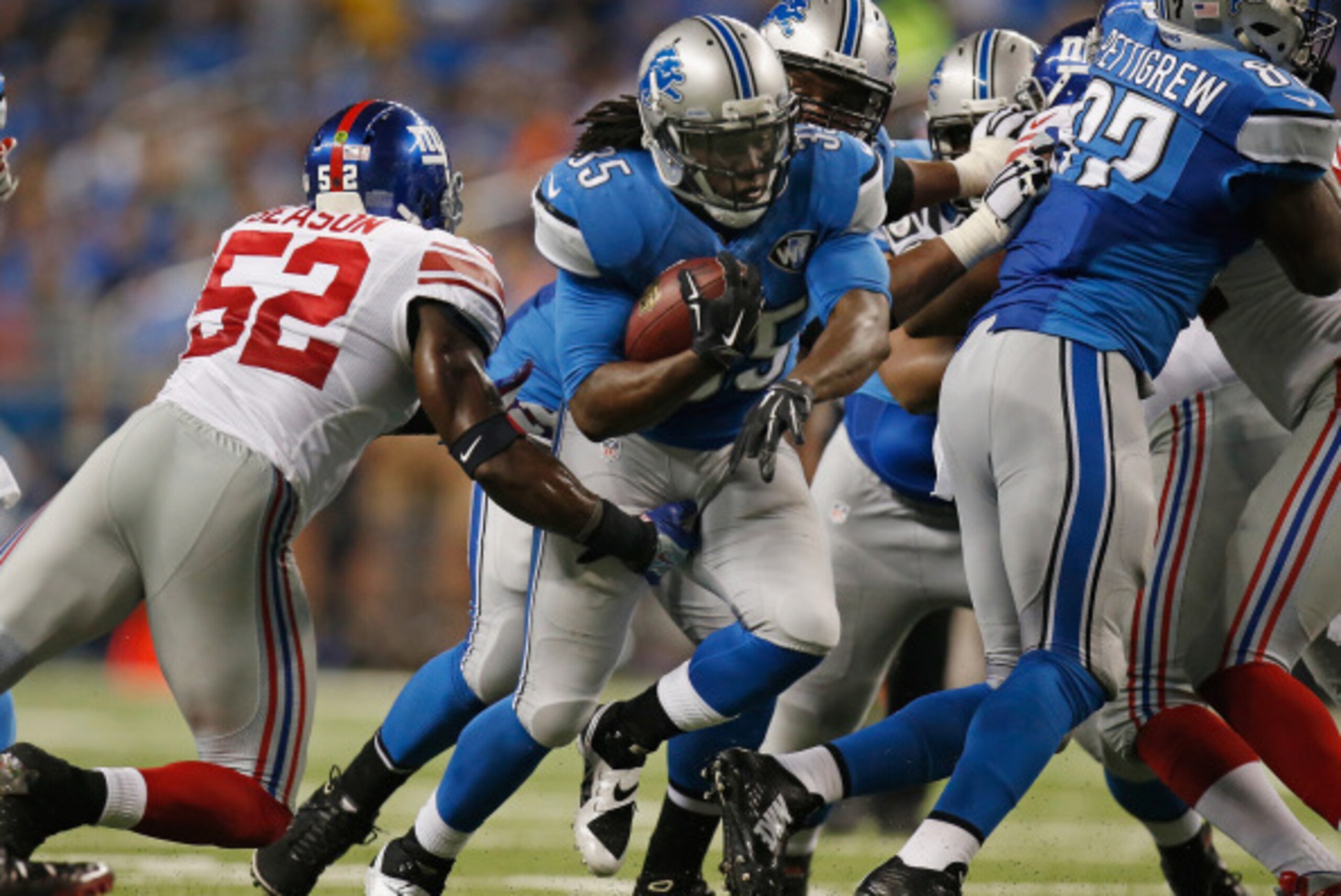 DETROIT, MI - SEPTEMBER 08: Joique Bell #35 of the Detroit Lions tries to avoid the tackle by Jon Beason #52 of the New York Giants in a third quarter run at Ford Field on September 8, 2014 in Detroit, Michigan. (Photo by Gregory Shamus/Getty Images)