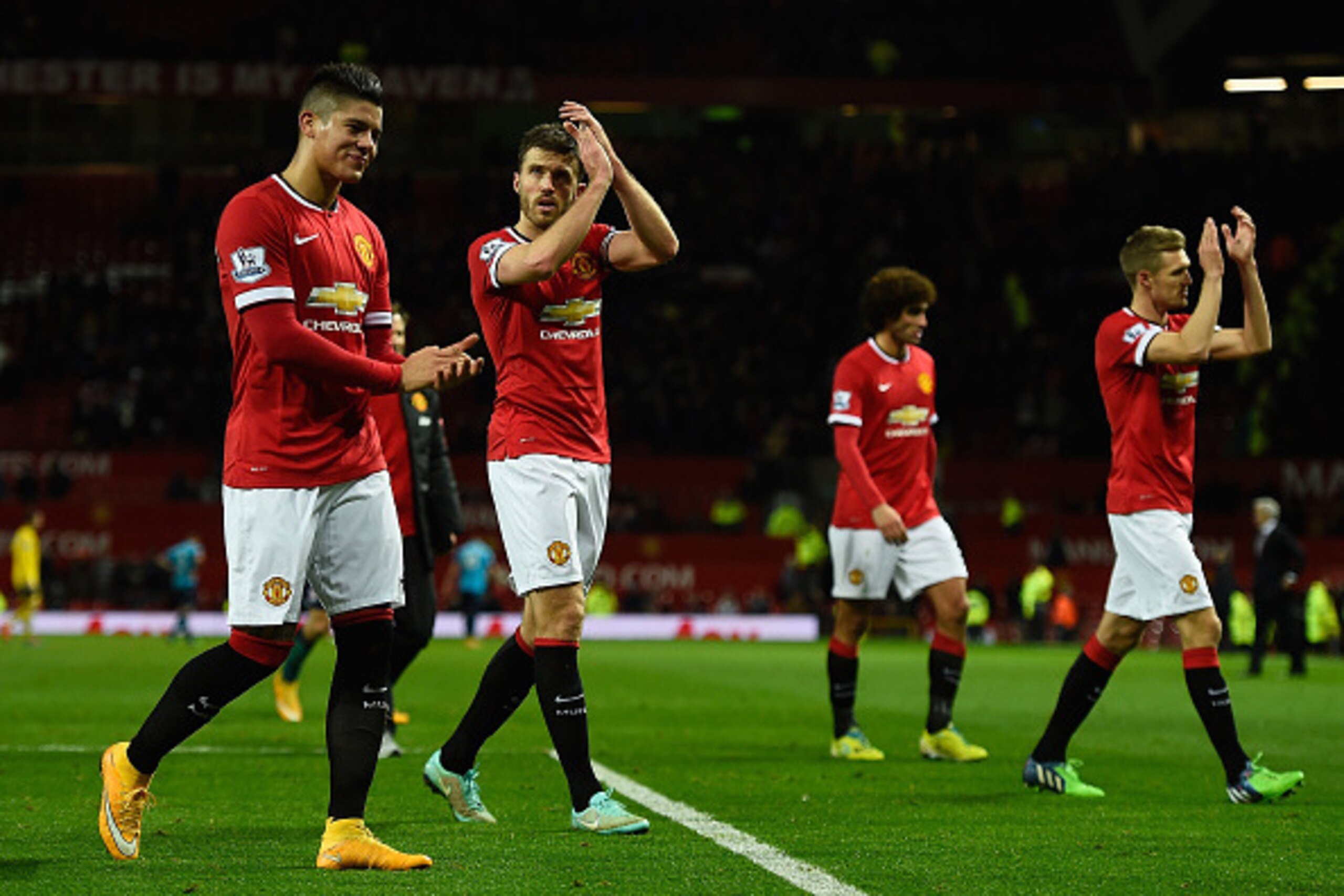 MANCHESTER, ENGLAND - DECEMBER 02:  Marcos Rojo and Michael Carrick of Manchester United applaud the fans at the end of the Barclays Premier League match between Manchester United and Stoke City at Old Trafford on December 2, 2014 in Manchester, England. 