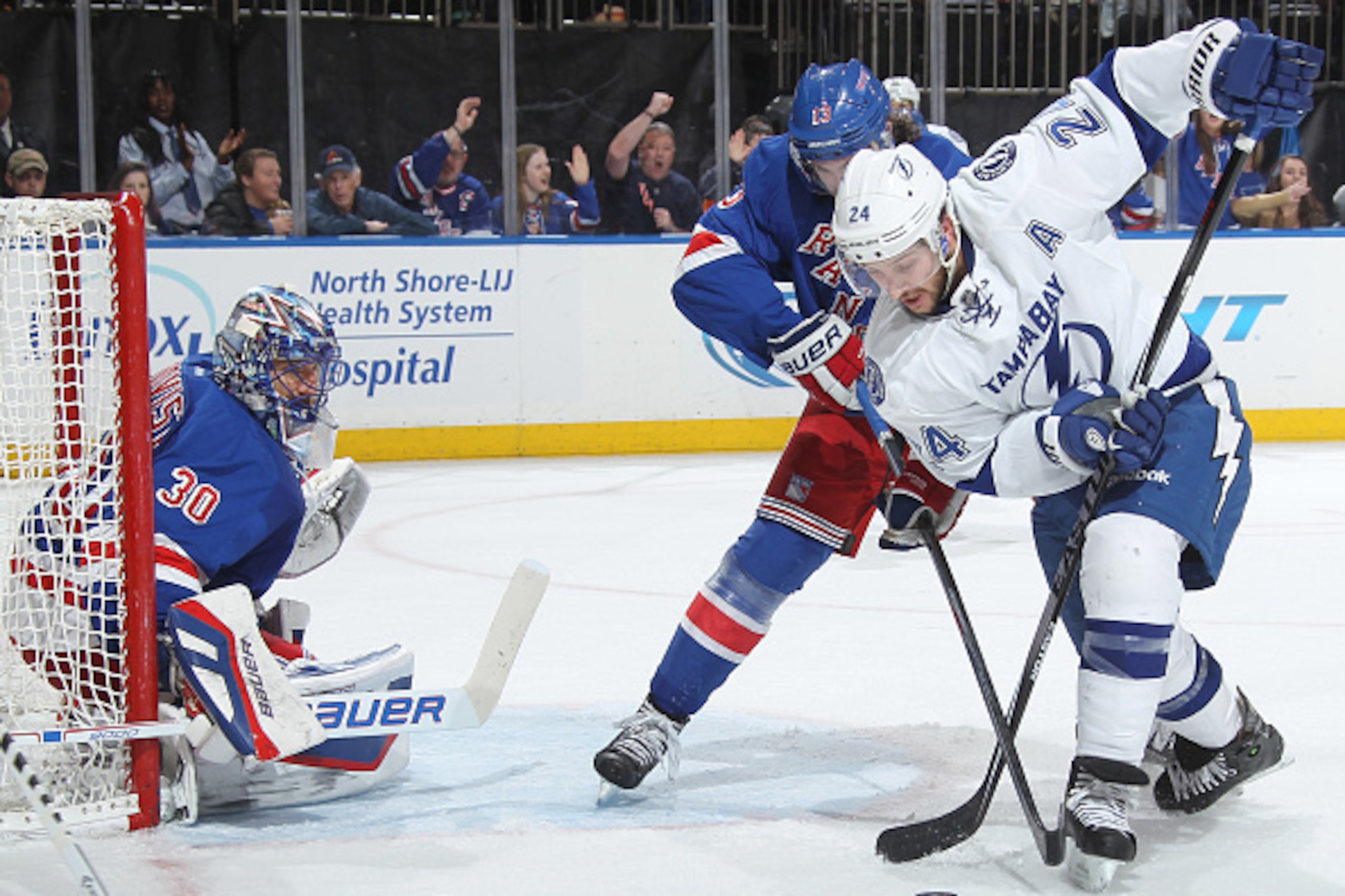 NEW YORK, NY - DECEMBER 01:  Ryan Callahan #24 of the Tampa Bay Lightning and Kevin Hayes #13 of the New York Rangers battle for the puck in front of Rangers goalie Henrik Lundqvist #30 at Madison Square Garden on December 1, 2014 in New York City. (Photo