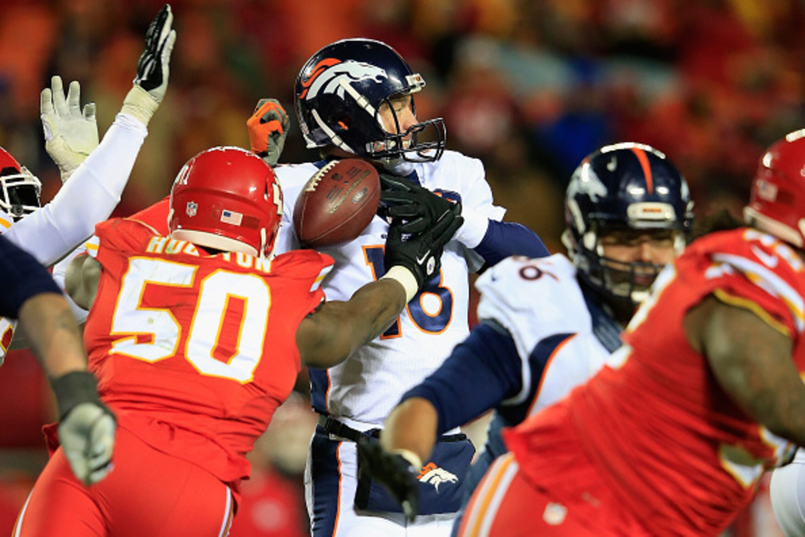 KANSAS CITY, MO - NOVEMBER 30:  Justin Houston #50 of the Kansas City Chiefs forces a fumble on  Peyton Manning #18 of the Denver Broncos during the third quarter at Arrowhead Stadium on November 30, 2014 in Kansas City, Missouri.  (Photo by Jamie Squire/