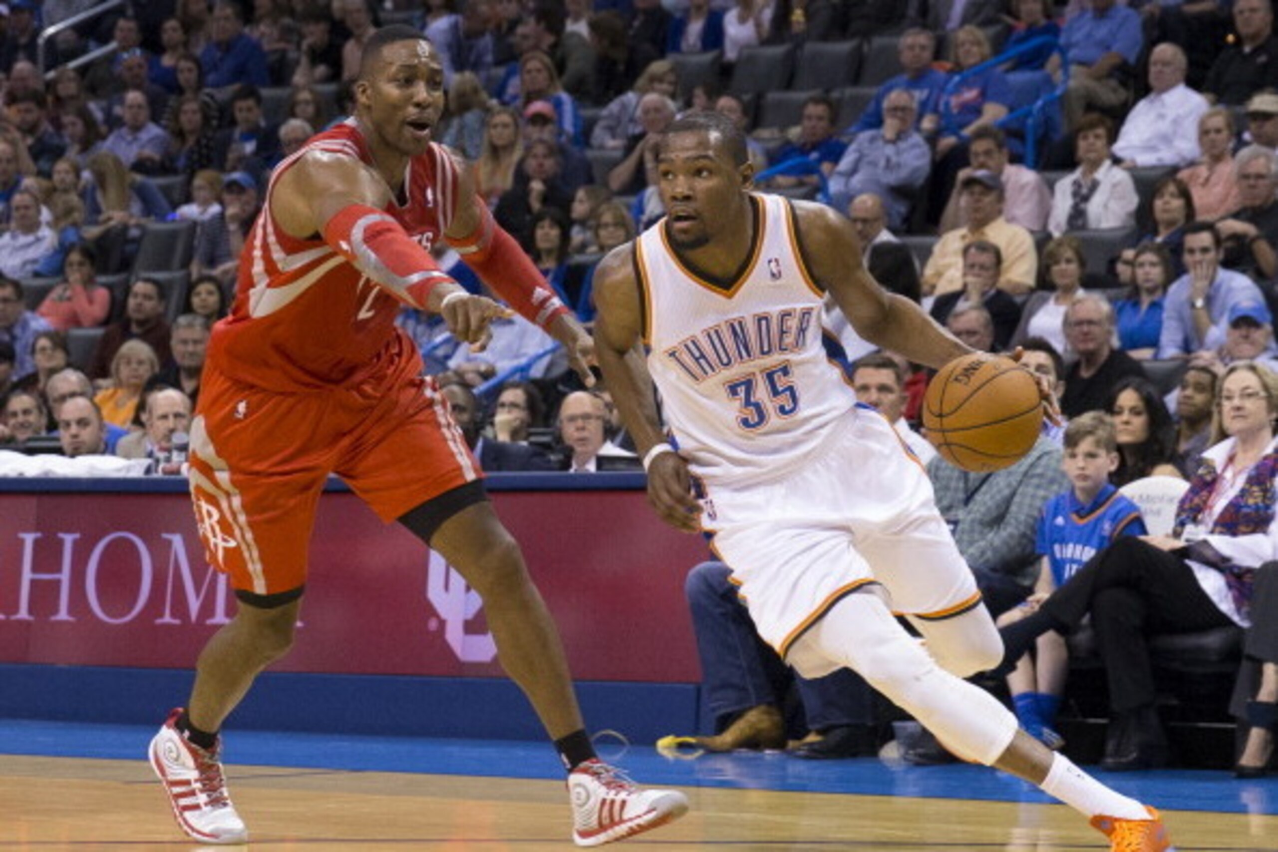 OKLAHOMA CITY, OK - MARCH 11, 2014:  Kevin Durant #35 of the Oklahoma City Thunder handles the ball against Dwight Howard #12 of the Houston Rockets at the Chesapeake Arena on March 11, 2014 in Oklahoma City, Oklahoma. NOTE TO USER:  User expressly acknow