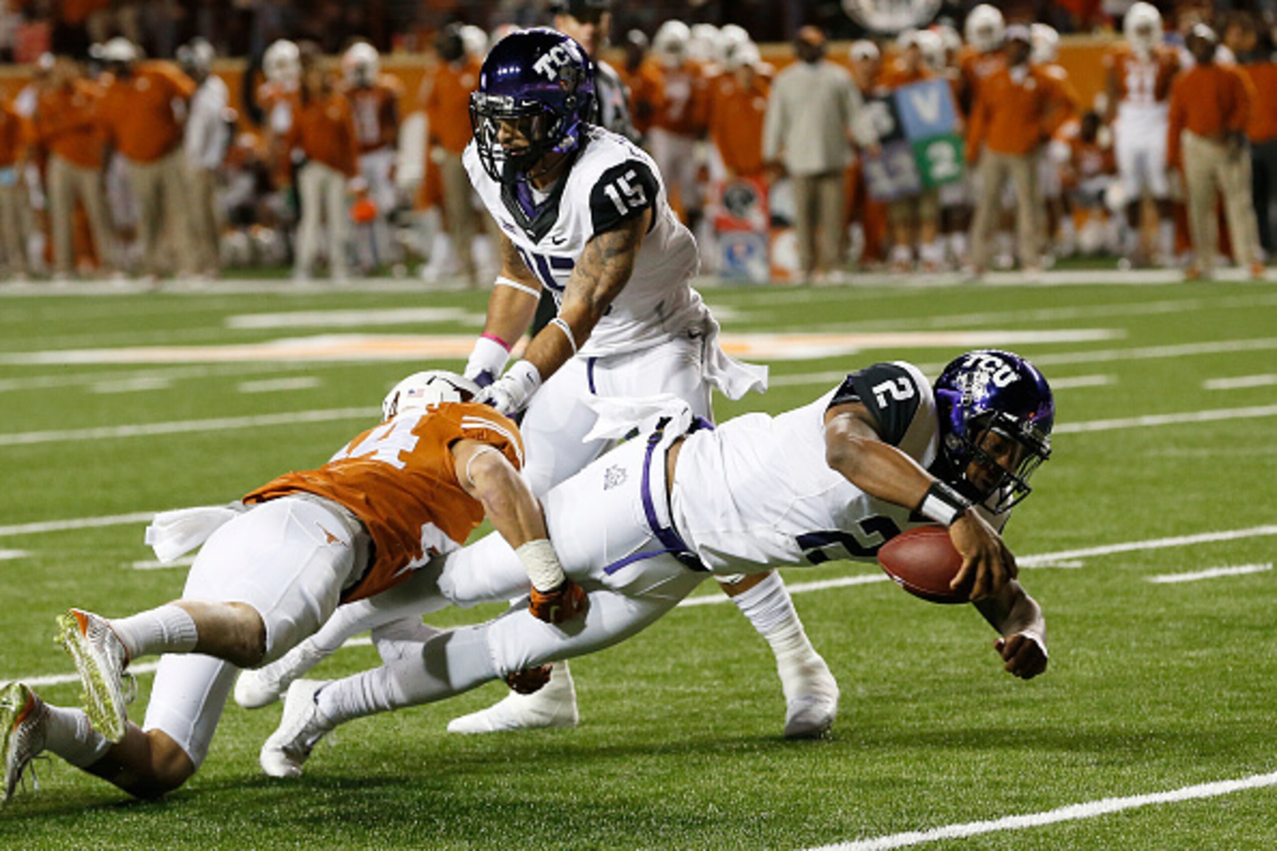 AUSTIN, TX - NOVEMBER 27: Trevone Boykin #2 of the TCU Horned Frogs is tackled by Dylan Haines #44 of the Texas Longhorns at the Darrell K Royal -Texas Memorial Stadium on November 27, 2014 in Austin. Texas. (Photo by Chris Covatta/Getty Images)
