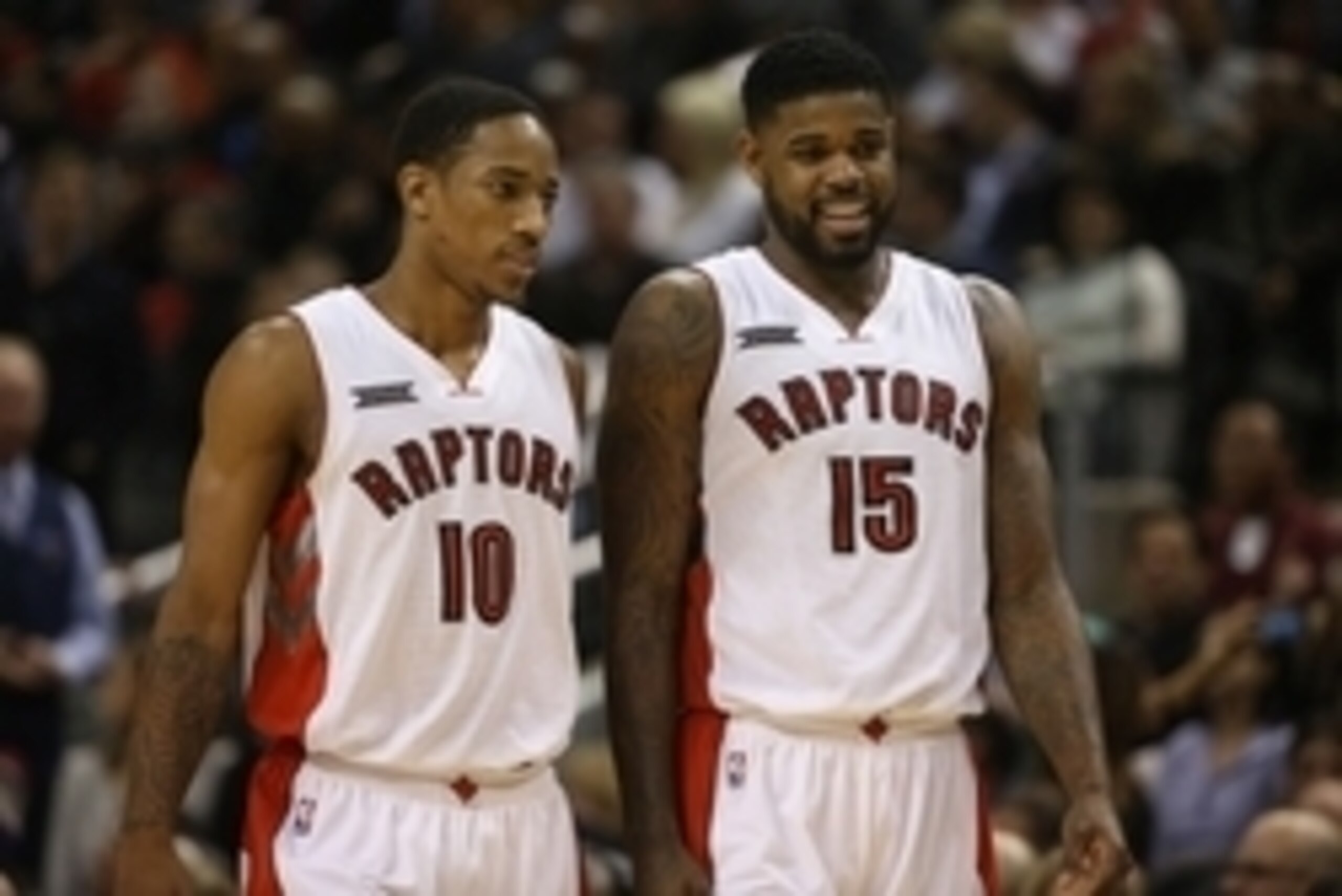 Nov 21, 2014; Toronto, Ontario, CAN; Toronto Raptors guard DeMar DeRozan (10) talks to forward Amir Johnson (15) against the Milwaukee Bucks at Air Canada Centre. The Raptors beat the Bucks 124-83. Mandatory Credit: Tom Szczerbowski-USA TODAY Sports