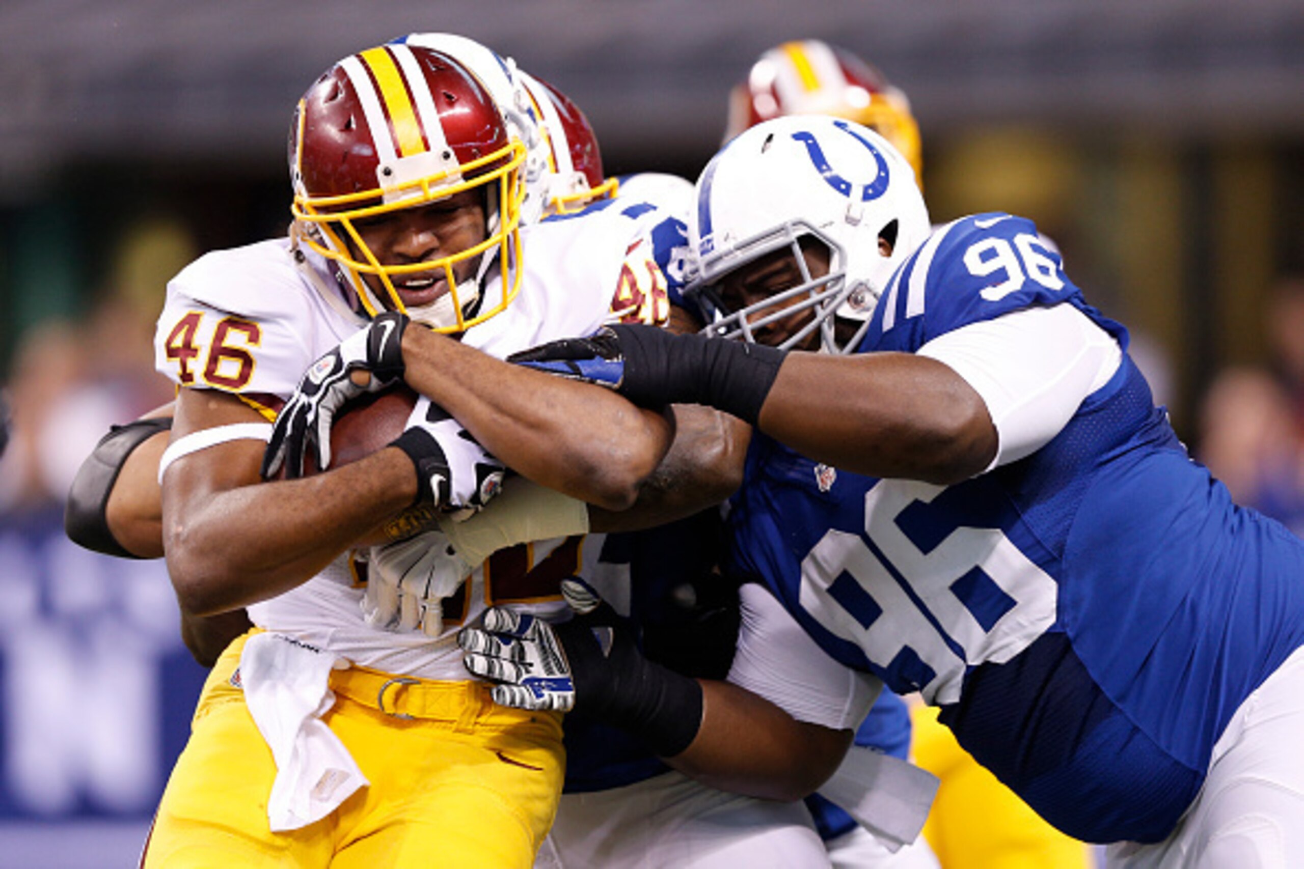 INDIANAPOLIS, IN - NOVEMBER 30: Josh Chapman #96 of the Indianapolis Colts tackles Alfred Morris #46 of the Washington Redskins during the first half of the game at Lucas Oil Stadium on November 30, 2014 in Indianapolis, Indiana. (Photo by Joe Robbins/Get