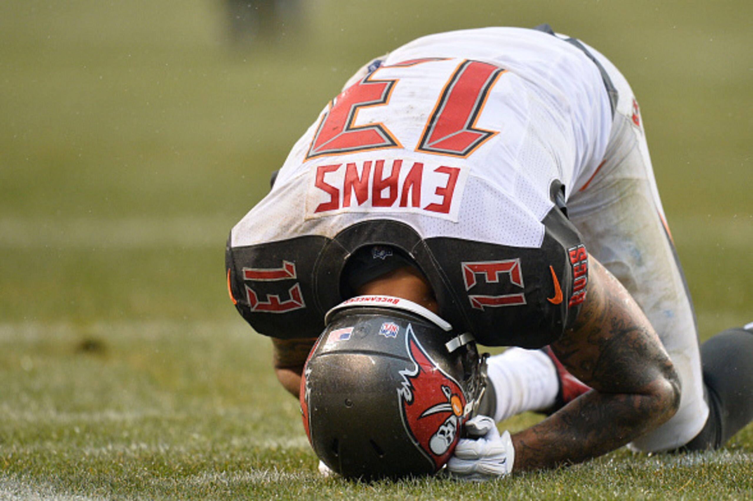 CHICAGO, IL - NOVEMBER 23:  Wide receiver Mike Evans #13 of the Tampa Bay Buccaneers holds his head after he was hit hard while unsuccessfully trying to catch a pass during the fourth quarter against the Chicago Bears on November 23, 2014 at Soldier Field
