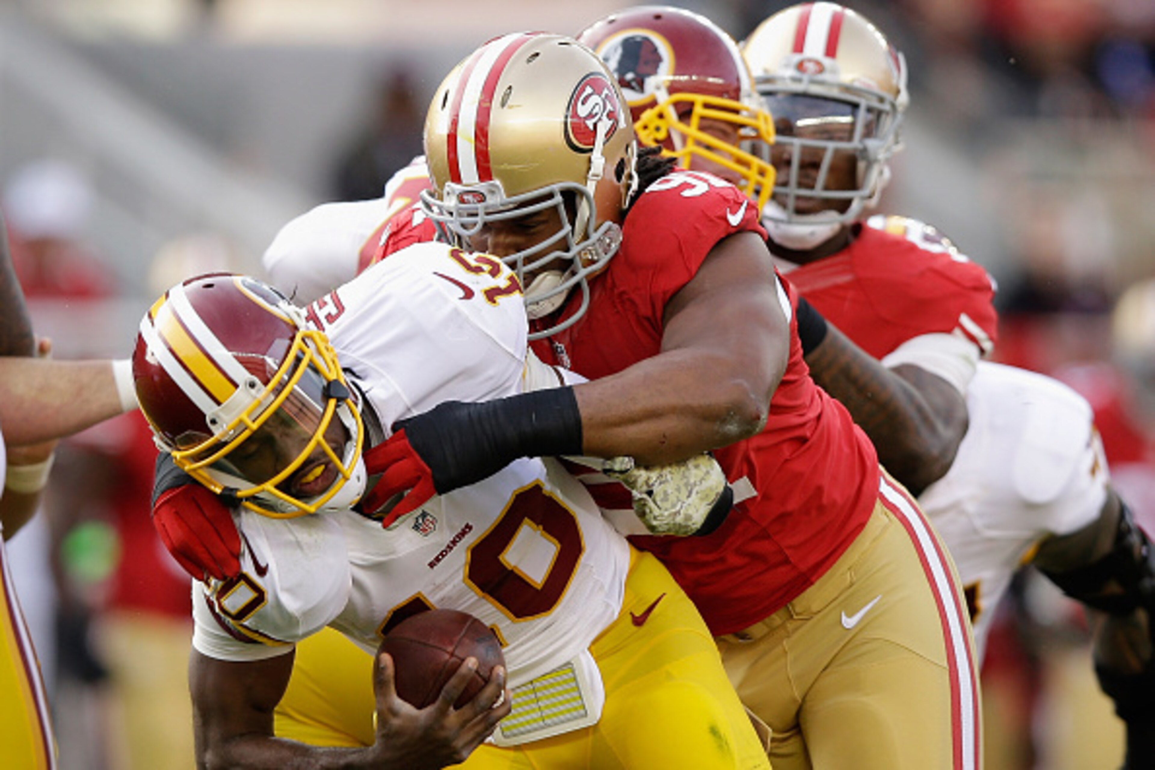 SANTA CLARA, CA - NOVEMBER 23: Robert Griffin III #10 of the Washington Redskins is sacked by Ray McDonald #91 of the San Francisco 49ers in the first half at Levi's Stadium on November 23, 2014 in Santa Clara, California.  (Photo by Ezra Shaw/Getty Image