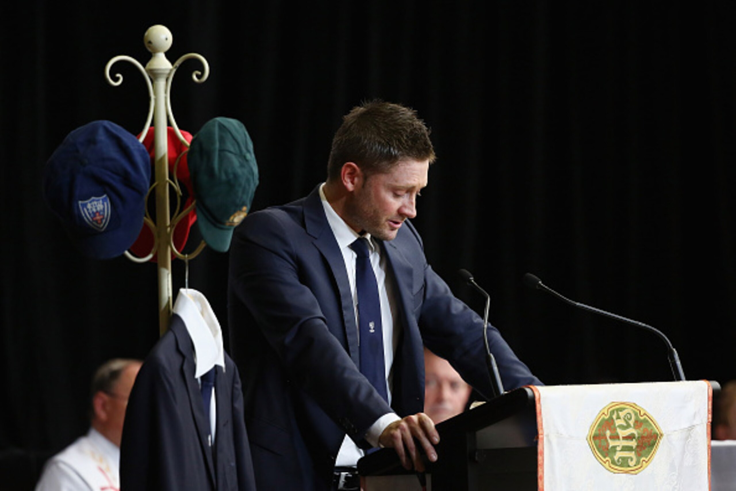 MACKSVILLE, AUSTRALIA - DECEMBER 03:  Australian cricket captain Michael Clarke pays tribute to Phillip Hughes during the Funeral Service for Phillip Hughes at Macksville High School Stadium on December 3, 2014 in Macksville, Australia. Australian cricket