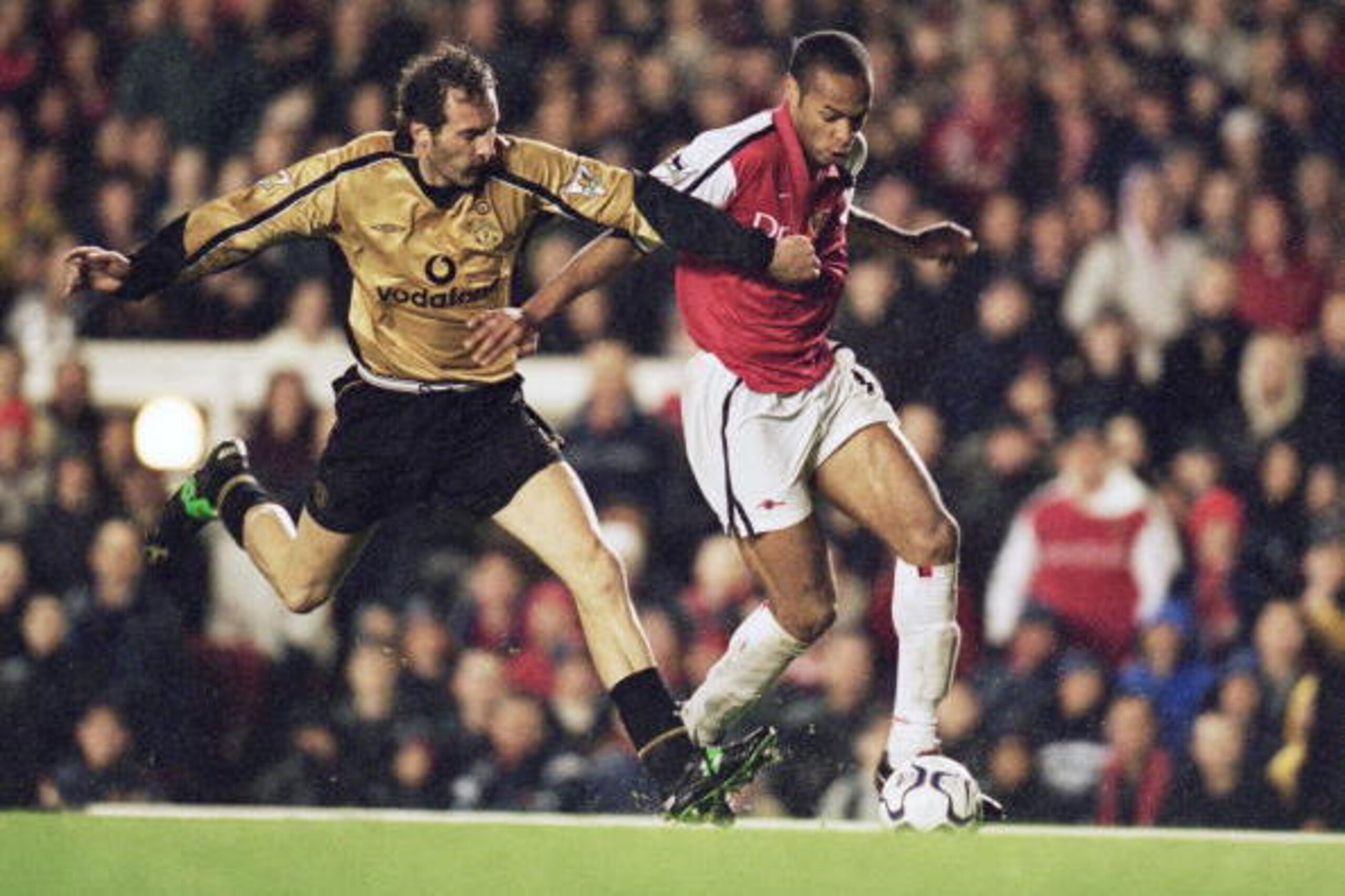 25 Nov 2001:  Thierry Henry of Arsenal takes the ball past Laurent Blanc of Manchester United during the FA Barclaycard Premiership match played at Highbury, in London. Arsenal won the match 3-1. \ Mandatory Credit: Phil Cole /Allsport