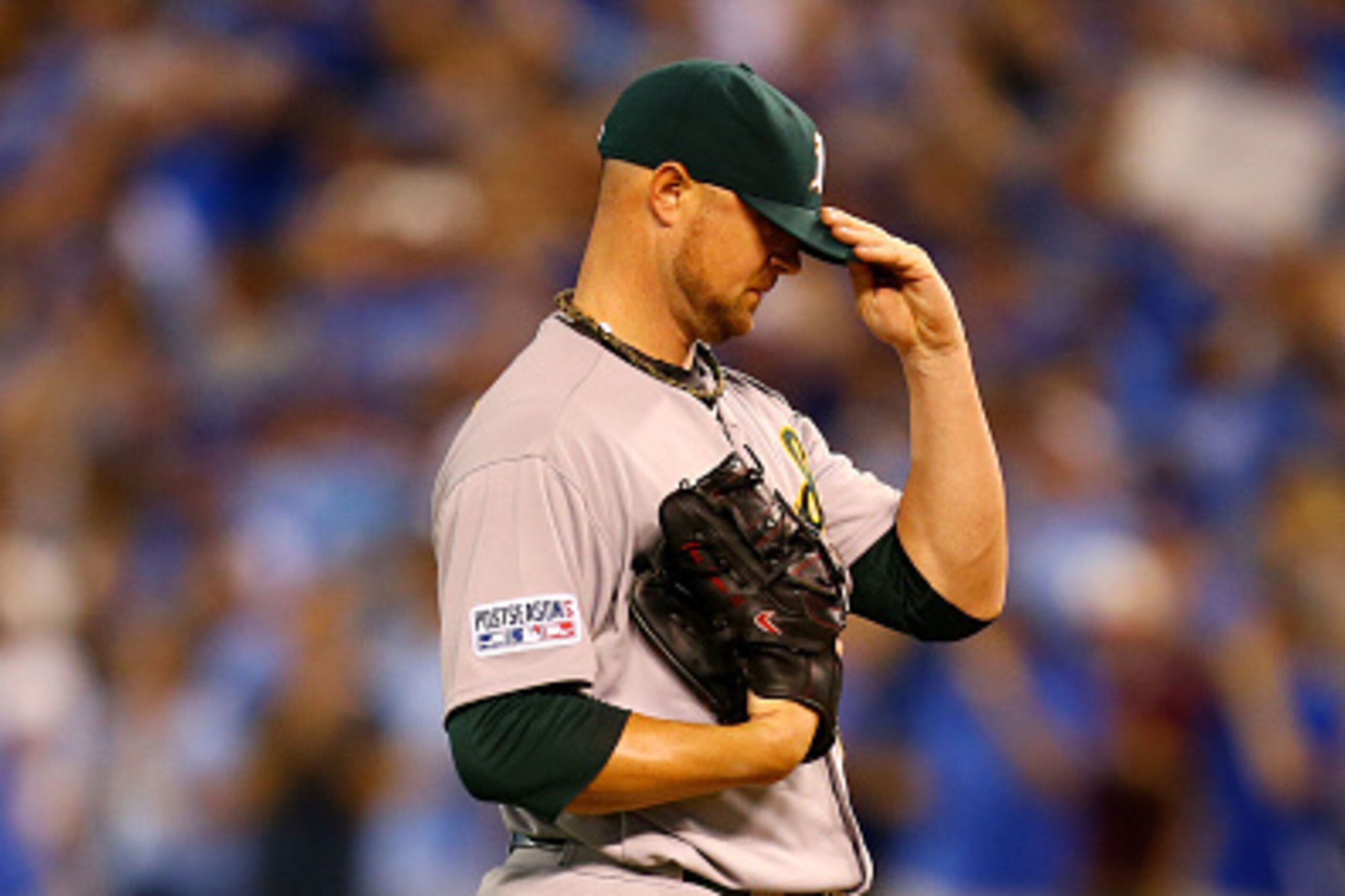 KANSAS CITY, MO - SEPTEMBER 30:  Jon Lester #31 of the Oakland Athletics reacts after Lorenzo Cain #6 of the Kansas City Royals scored in the third inning during the American League Wild Card game at Kauffman Stadium on September 30, 2014 in Kansas City, 
