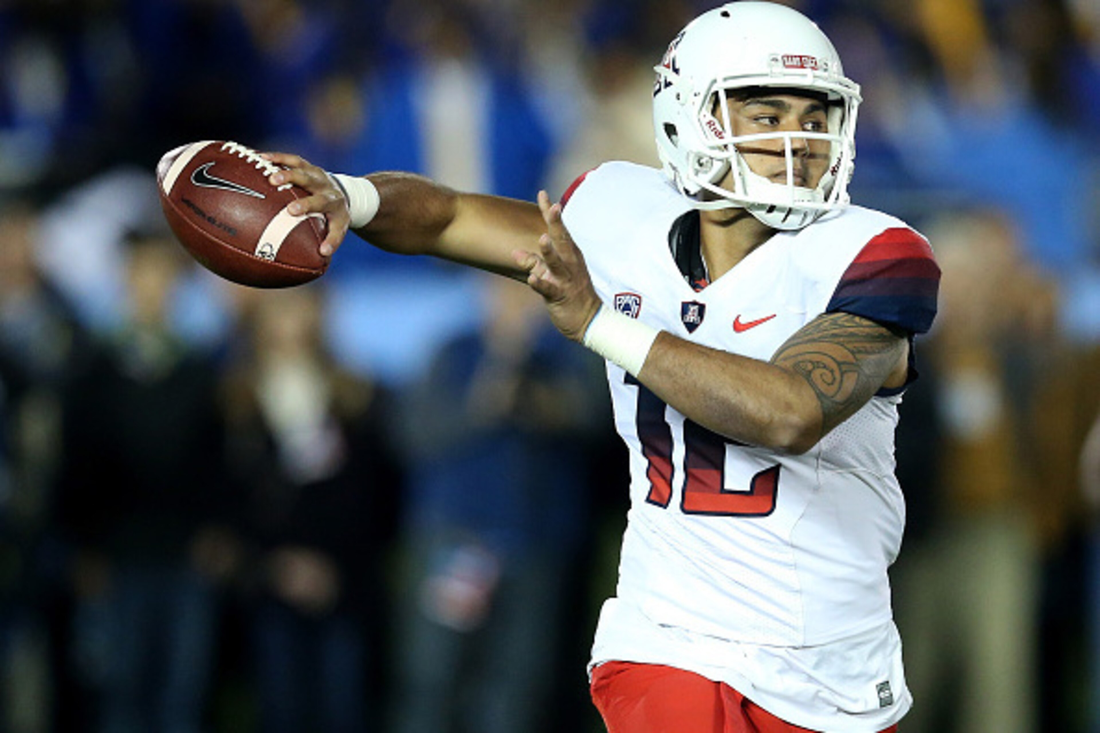 PASADENA, CA - NOVEMBER 01:  Quarterback Anu Solomon #12 of the Arizona Wildcats rolls out to throw a pass against the UCLA Bruins at the Rose Bowl on November 1, 2014 in Pasadena, California.  (Photo by Stephen Dunn/Getty Images)