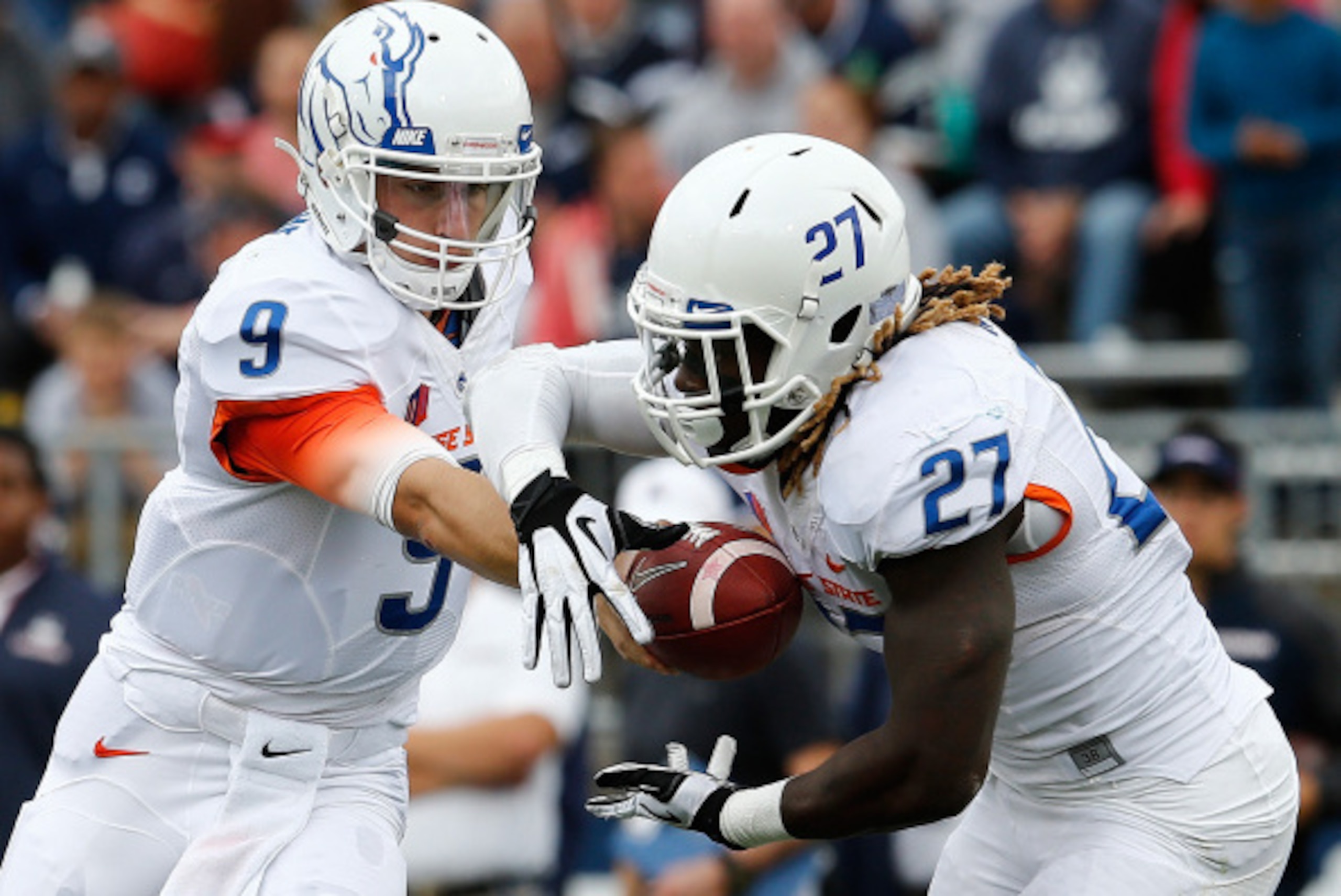 BOSTON, MA - SEPTEMBER 13:   Grant Hedrick #9 of the Boise State Broncos hands the ball to running back Jay Ajayi #27 in the first quarter  against the Connecticut Huskies at Rentschler Field on September 13, 2014 in East Hartford, Connecticut. (Photo by 