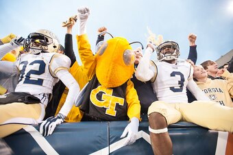 ATLANTA, GA - NOVEMBER 1: Linebacker Jabari Hunt-Days #32  and running back Dennis Andrews #3 of the Georgia Tech Yellow Jackets celebrates with their mascot Buzz on November 1, 2014 at Bobby Dodd Stadium in Atlanta, Georgia. The Georgia Tech Yellow Jacke