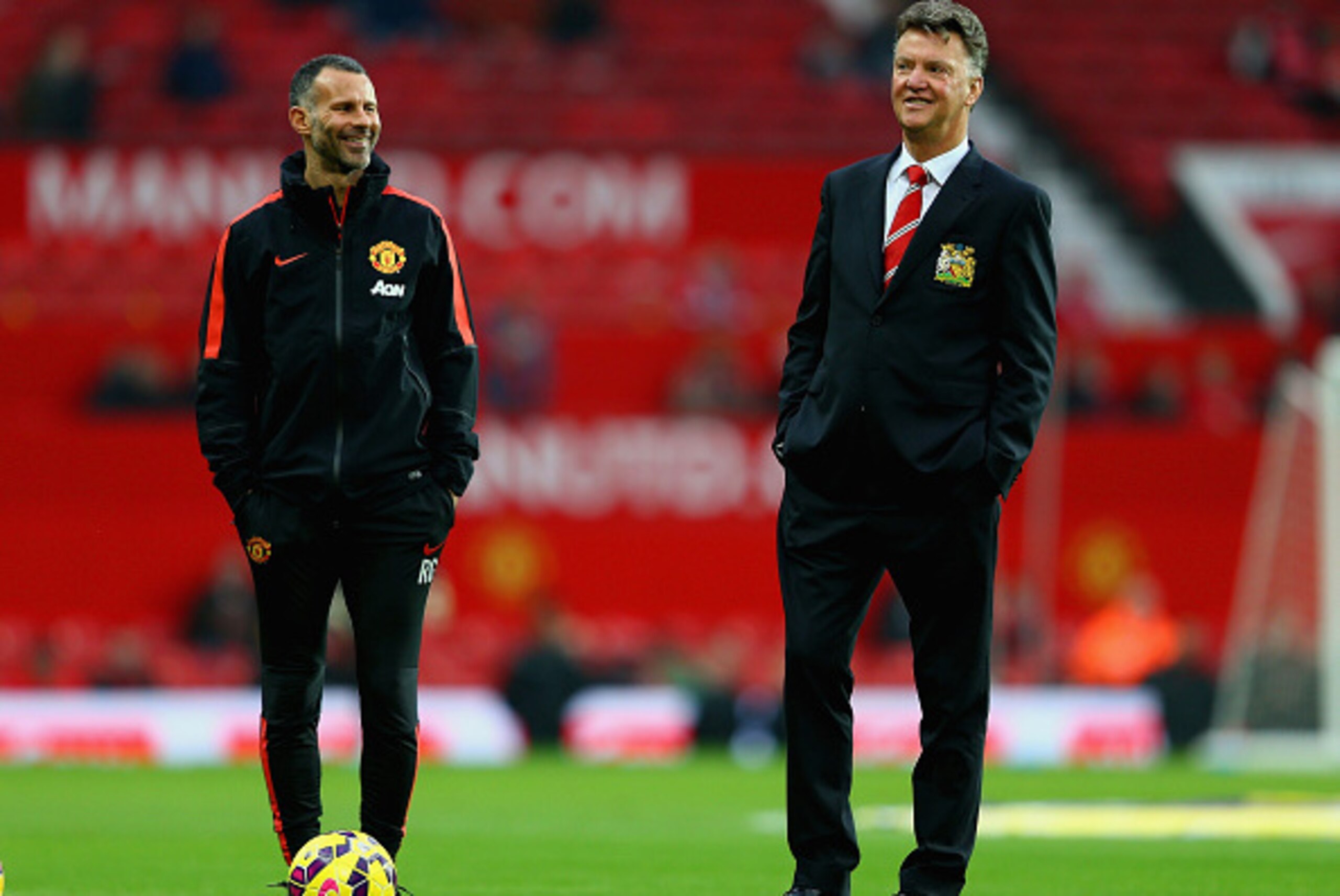 MANCHESTER, ENGLAND - NOVEMBER 29: Assistant Ryan Gigg of Manchester United and Manager Louis van Gaal of Manchester United walk on the pitch prior to the Barclays Premier League match between Manchester United and Hull City at Old Trafford on November 29
