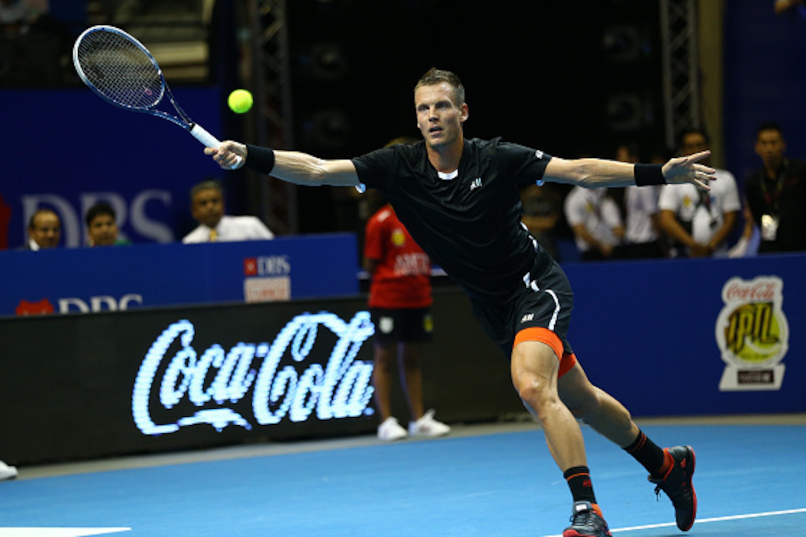 SINGAPORE - DECEMBER 02:  Tomas Berdych of the Singapore Slammers plays a forehand against Jo-Wilfried Tsonga of the Manila Mavericks during the Coca-Cola International Premier Tennis League at the Singapore Sports Hub on December 2, 2014 in Singapore,  (