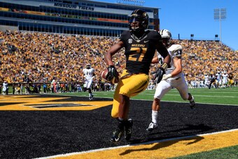 COLUMBIA, MO - SEPTEMBER 13:  Wide receiver Bud Sasser #21 of the Missouri Tigers makes a catch in the end zone for a touchdown as defensive back Jordan Ozerities #38 of the UCF Knights defends during the second half of the game on September 13, 2014 at F