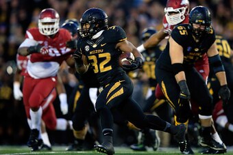 COLUMBIA, MO - NOVEMBER 28:  Russell Hansbrough #32 of the Missouri Tigers carries the ball during the game against the Arkansas Razorbacks at Faurot Field/Memorial Stadium on November 28, 2014 in Columbia, Missouri.  (Photo by Jamie Squire/Getty Images)