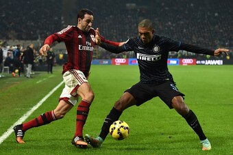 MILAN, ITALY - NOVEMBER 23:  Adil Rami (R) of AC Milan is challenged by Juan Jesus of FC Internazionale Milano during the Serie A match between AC Milan and FC Internazionale Milano at Stadio Giuseppe Meazza on November 23, 2014 in Milan, Italy.  (Photo b