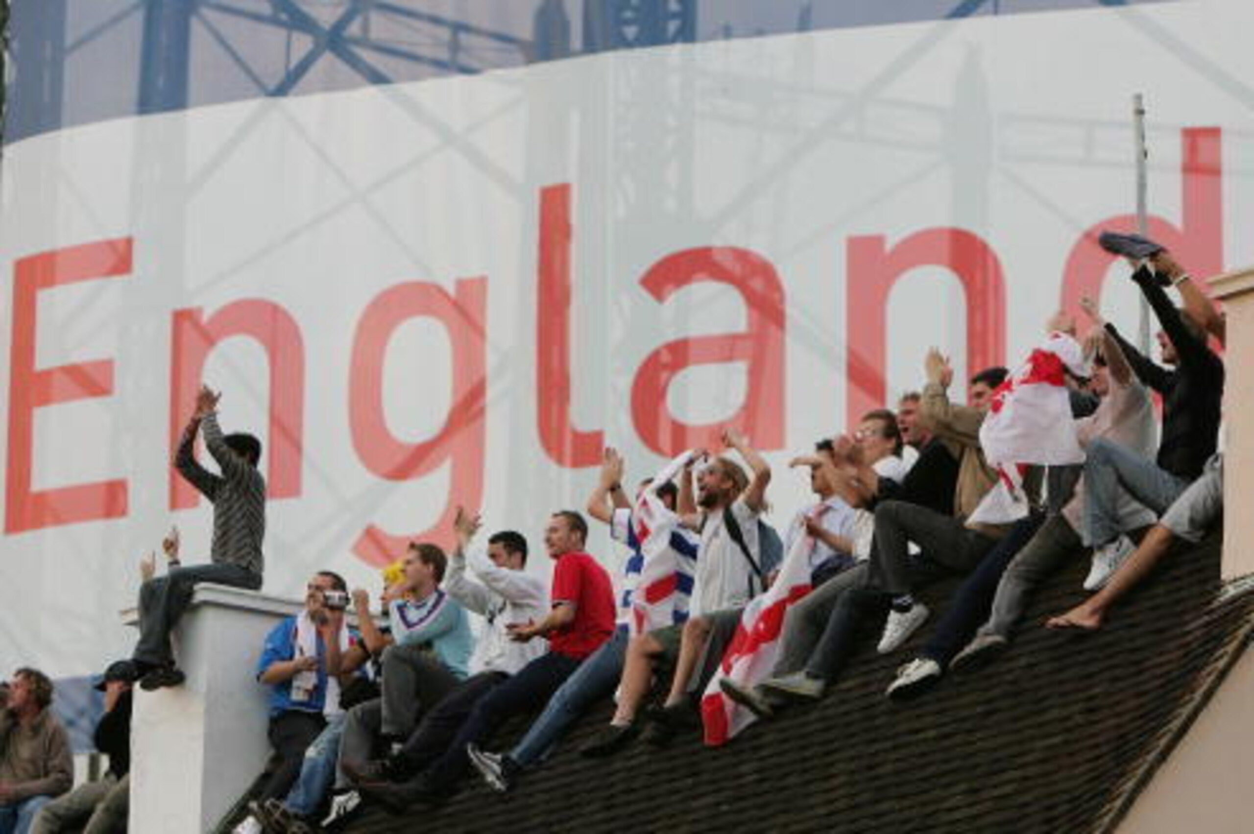 LONDON - SEPTEMBER 12:  People applaud from a rooftop overlooking the ground as England win the Ashes during day five of the Fifth npower Ashes Test match between England and Australia at the Brit Oval on September 12, 2005 in London, England. (Photo by S