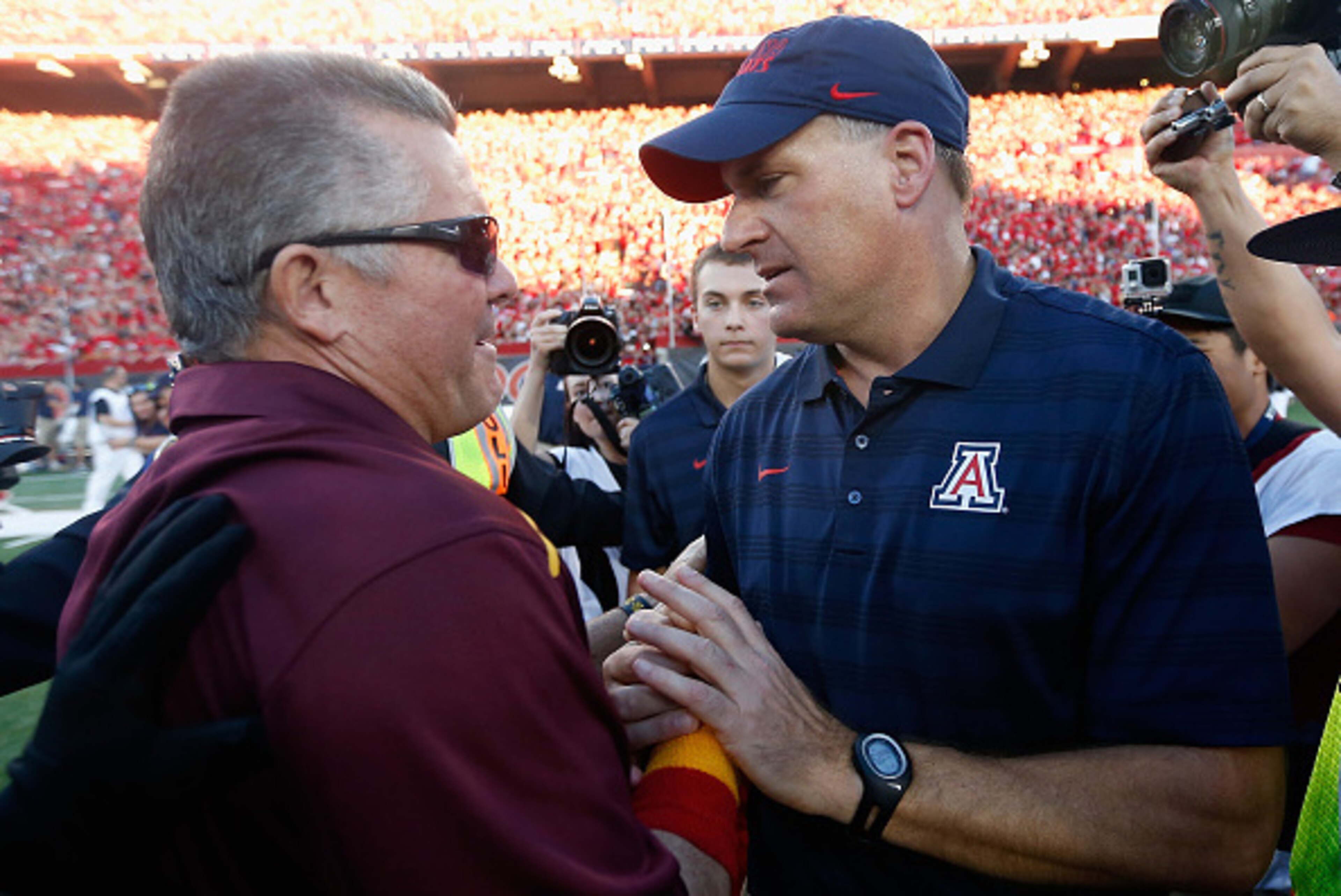 TUCSON, AZ - NOVEMBER 28:  Head coaches Rich Rodriguez (R) of the Arizona Wildcats and Todd Graham of the Arizona State Sun Devils shake hands after the Wildcats defeated the Sun Devils 42-35 to win PAC-12 south championship following the Territorial Cup 