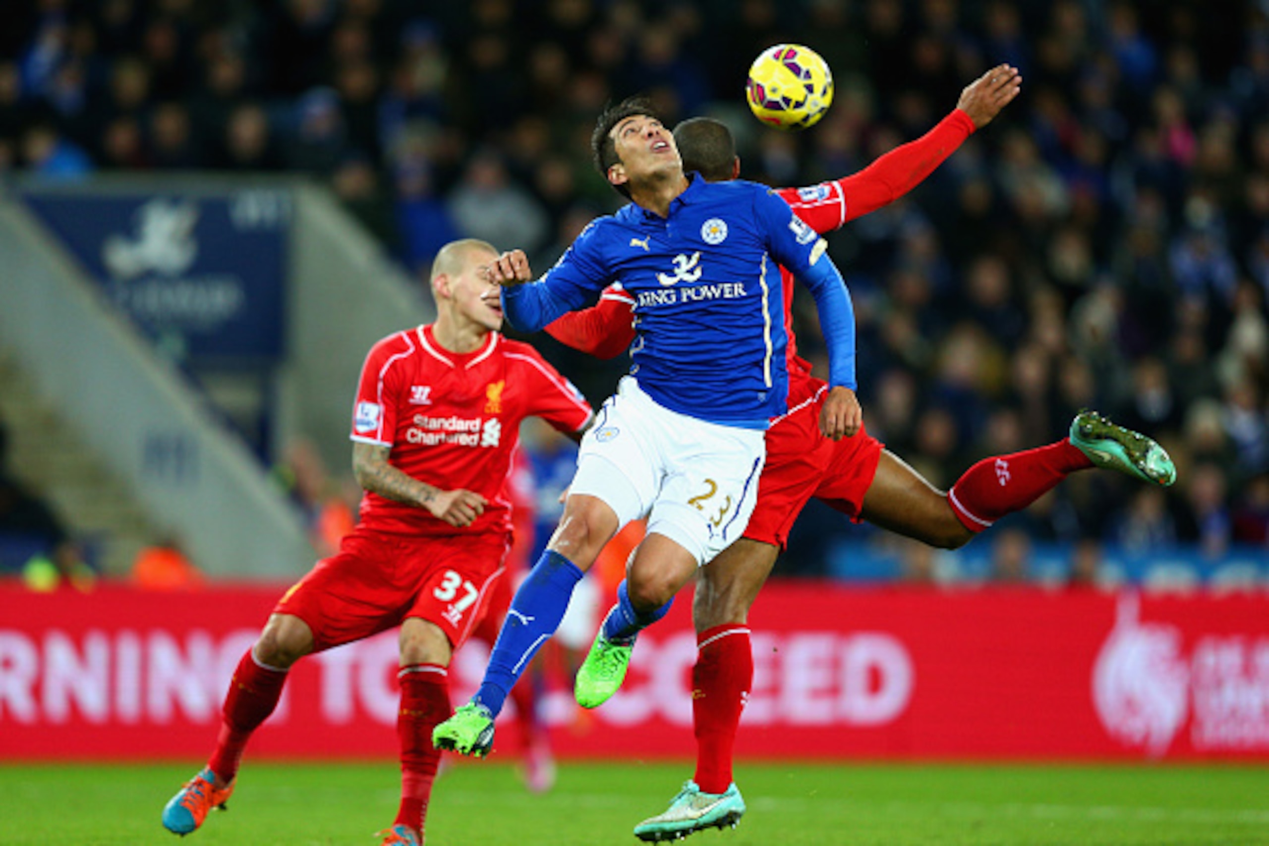 LEICESTER, ENGLAND - DECEMBER 02: Leonardo Ulloa of Leicester City and Glen Johnson of Liverpool compete for the ball during the Barclays Premier League match between Leicester City and Liverpool at The King Power Stadium on December 2, 2014 in Leicester,