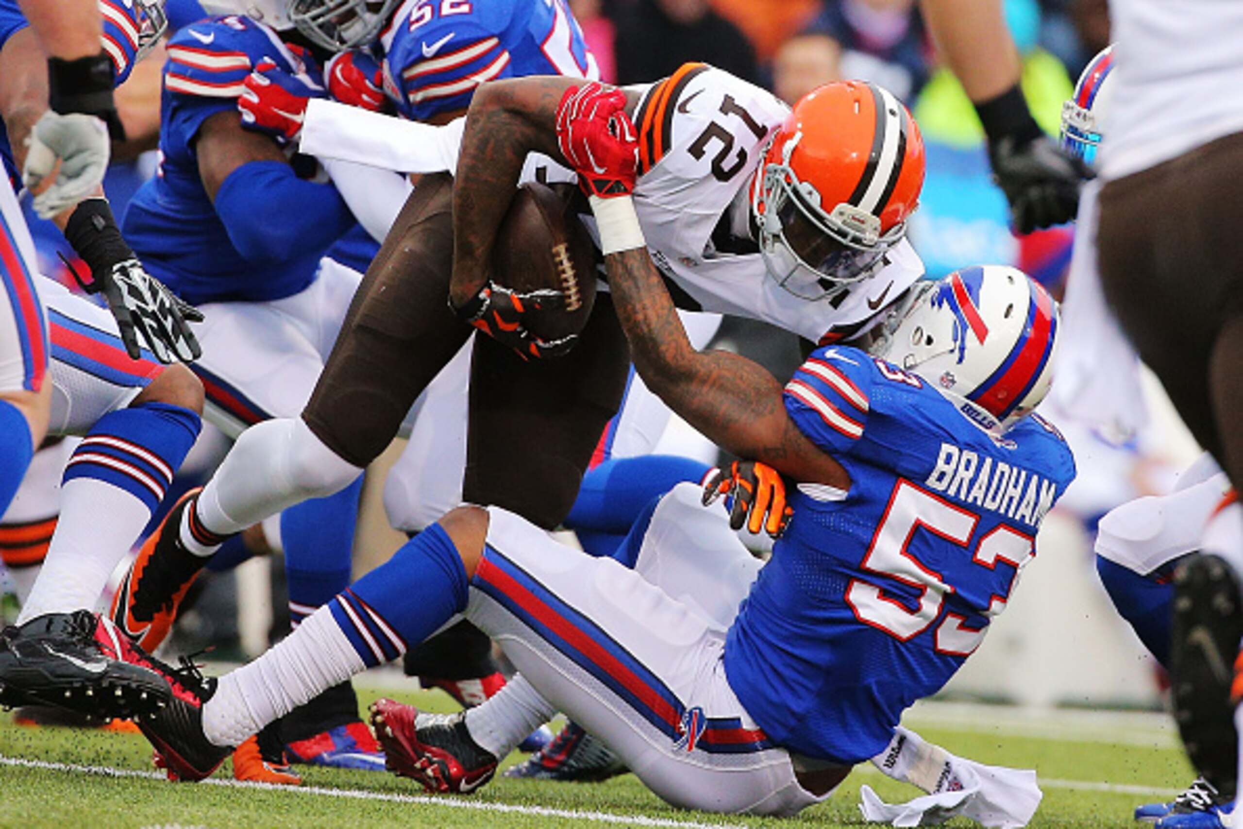 ORCHARD PARK, NY - NOVEMBER 30:   Josh Gordon #12 of the Cleveland Browns is tackled by Nigel Bradham #53 of the Buffalo Bills during the first half at Ralph Wilson Stadium on November 30, 2014 in Orchard Park, New York.  (Photo by Brett Carlsen/Getty Ima