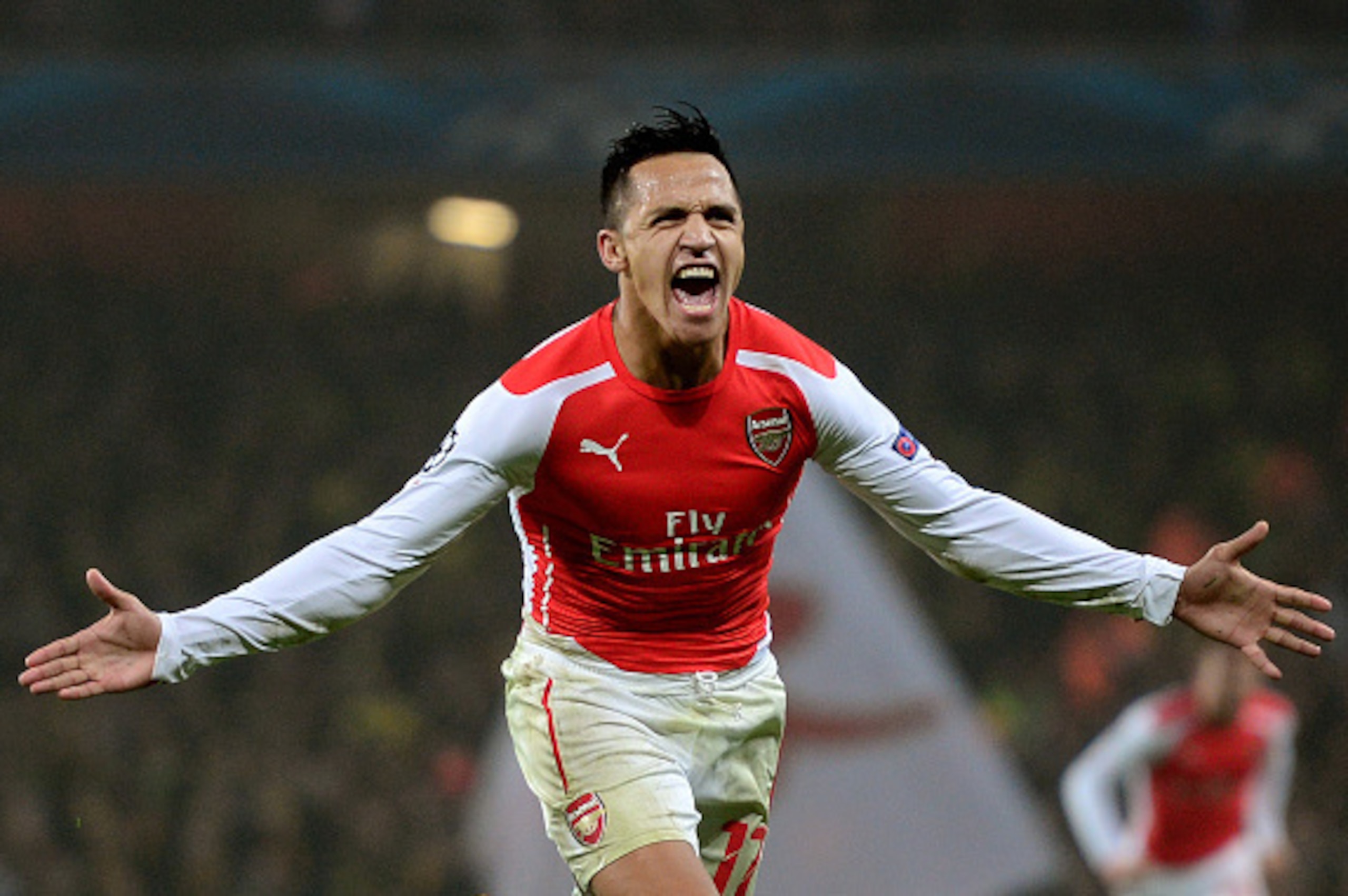 LONDON, ENGLAND - NOVEMBER 26:  Alexis Sanchez of Arsenal celebrates after scoring his team's second goal during the UEFA Champions League Group D match between Arsenal and Borussia Dortmund at the Emirates Stadium on November 26, 2014 in London, United K