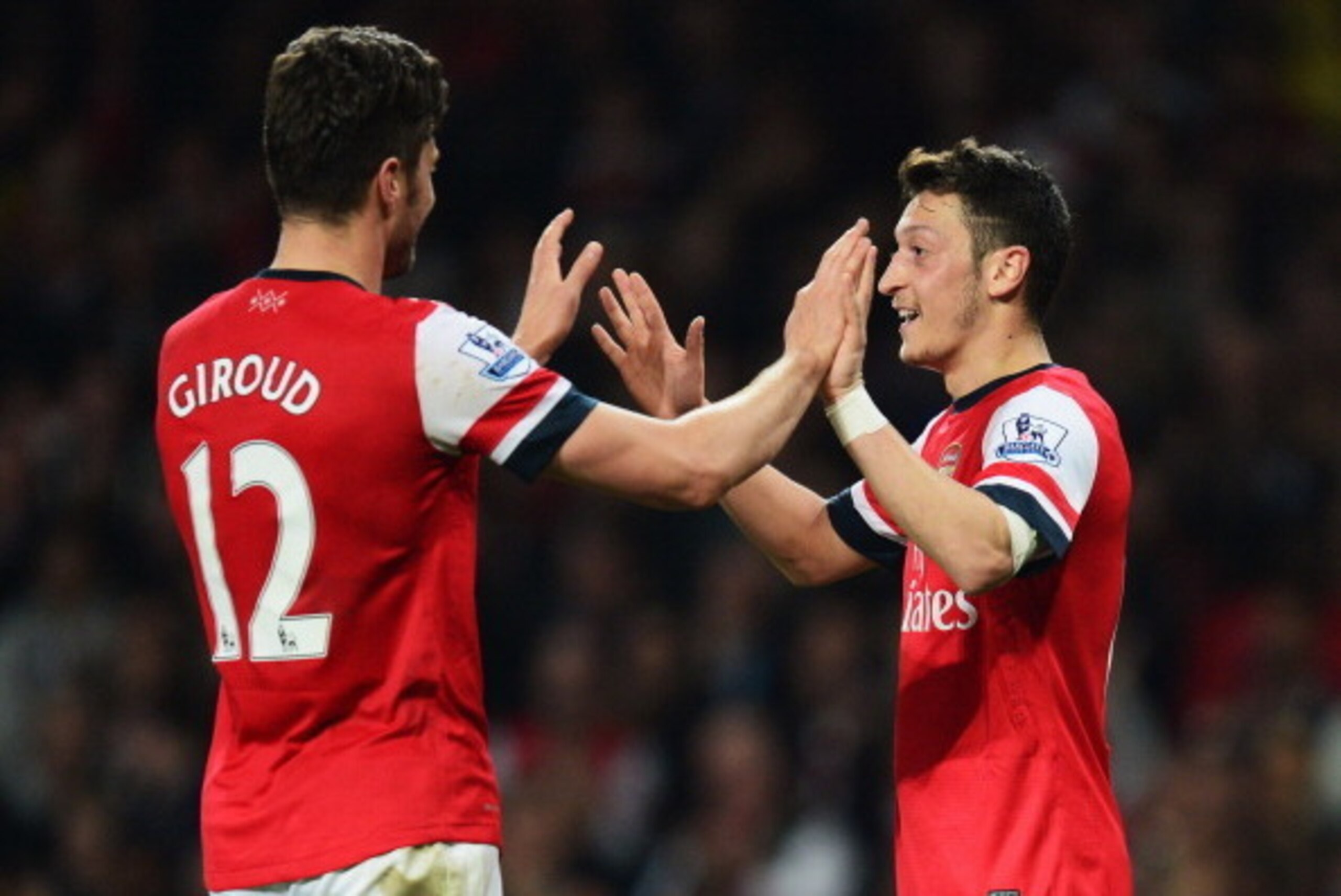 LONDON, ENGLAND - APRIL 28:  Mesut Oezil of Arsenal (11) celebrates with Olivier Giroud as he scores their second goal during the Barclays Premier League match between Arsenal and Newcastle United at Emirates Stadium on April 28, 2014 in London, England. 