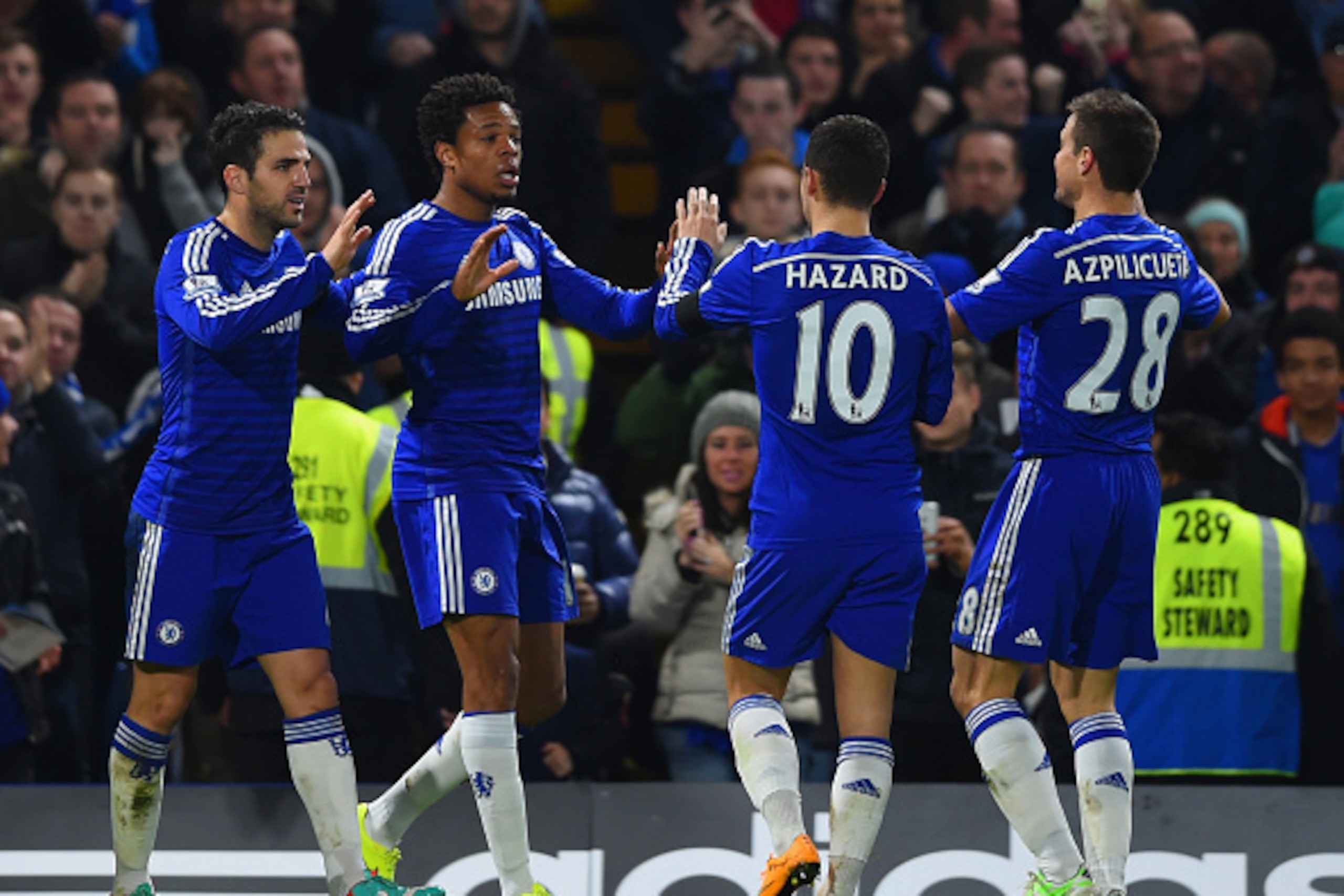 LONDON, ENGLAND - DECEMBER 03: Loic Remy of Chelsea (2L) celebrates scoring their third goal with Cesc Fabregas, Eden Hazard and Cesar Azpilicueta of Chelsea  during the Barclays Premier League match between Chelsea and Tottenham Hotspur at Stamford Bridg