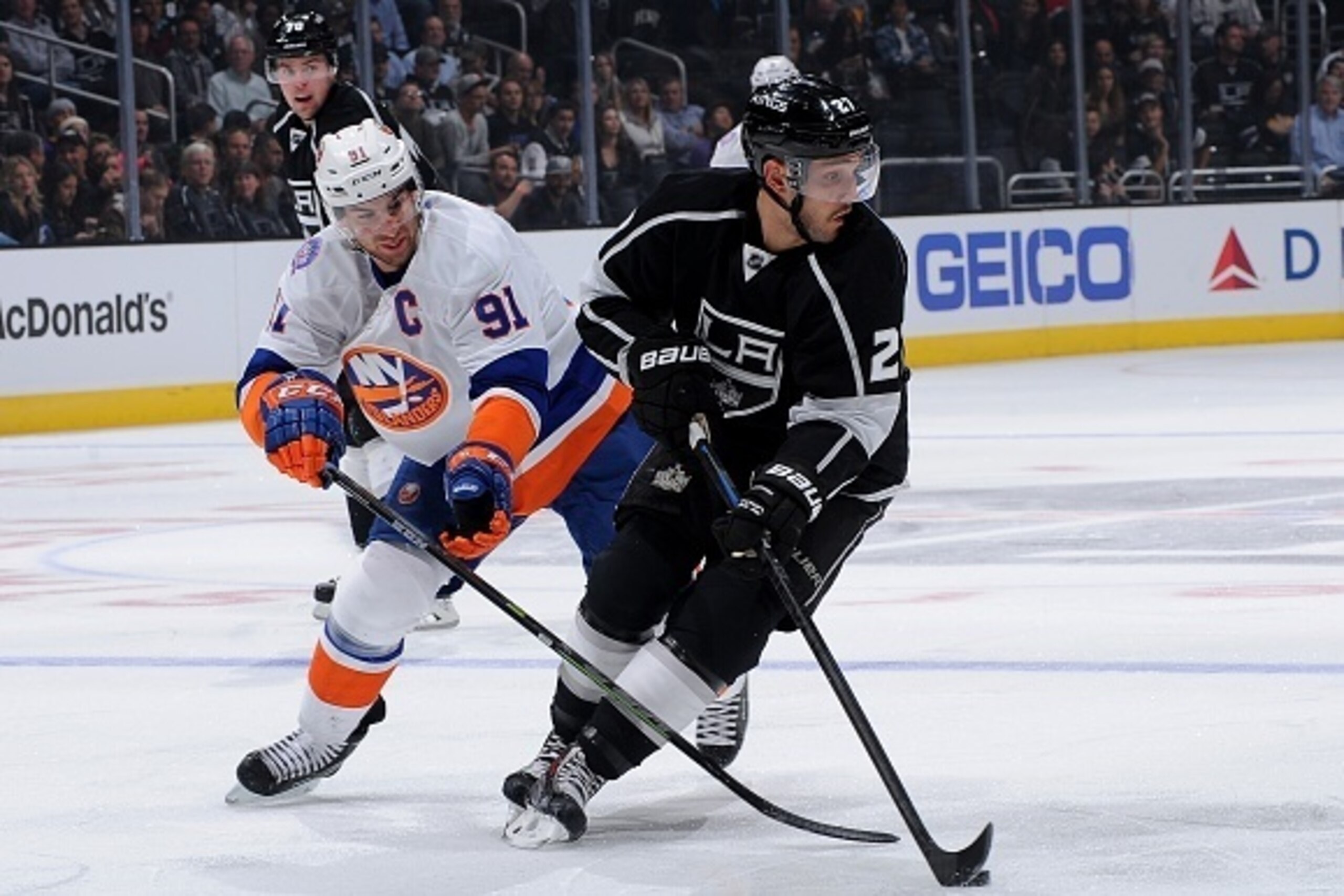 LOS ANGELES, CA - NOVEMBER 6: Alec Martinez #27 of the Los Angeles Kings handles the puck against John Tavares #91 of the New York Islanders during a game at STAPLES Center on November 6, 2014 in Los Angeles, California. (Photo by Juan Ocampo/NHLI via Get