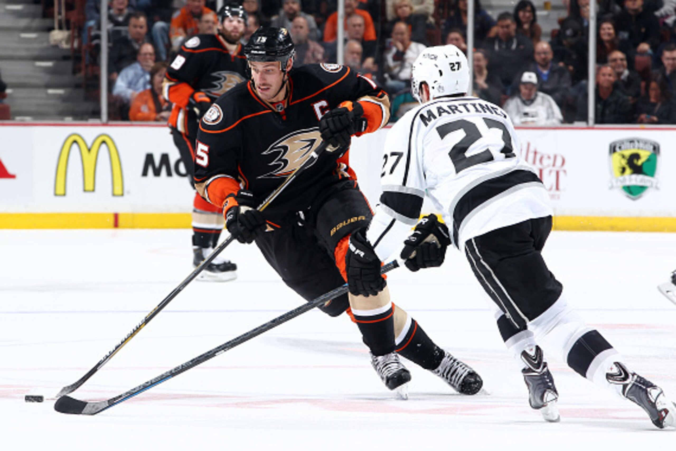 ANAHEIM, CA - NOVEMBER 12:  Ryan Getzlaf #15 of the Anaheim Ducks handles the puck against Alec Martinez #27 of the Los Angeles Kings on November 12, 2014 at Honda Center in Anaheim, California. (Photo by Debora Robinson/NHLI via Getty Images)