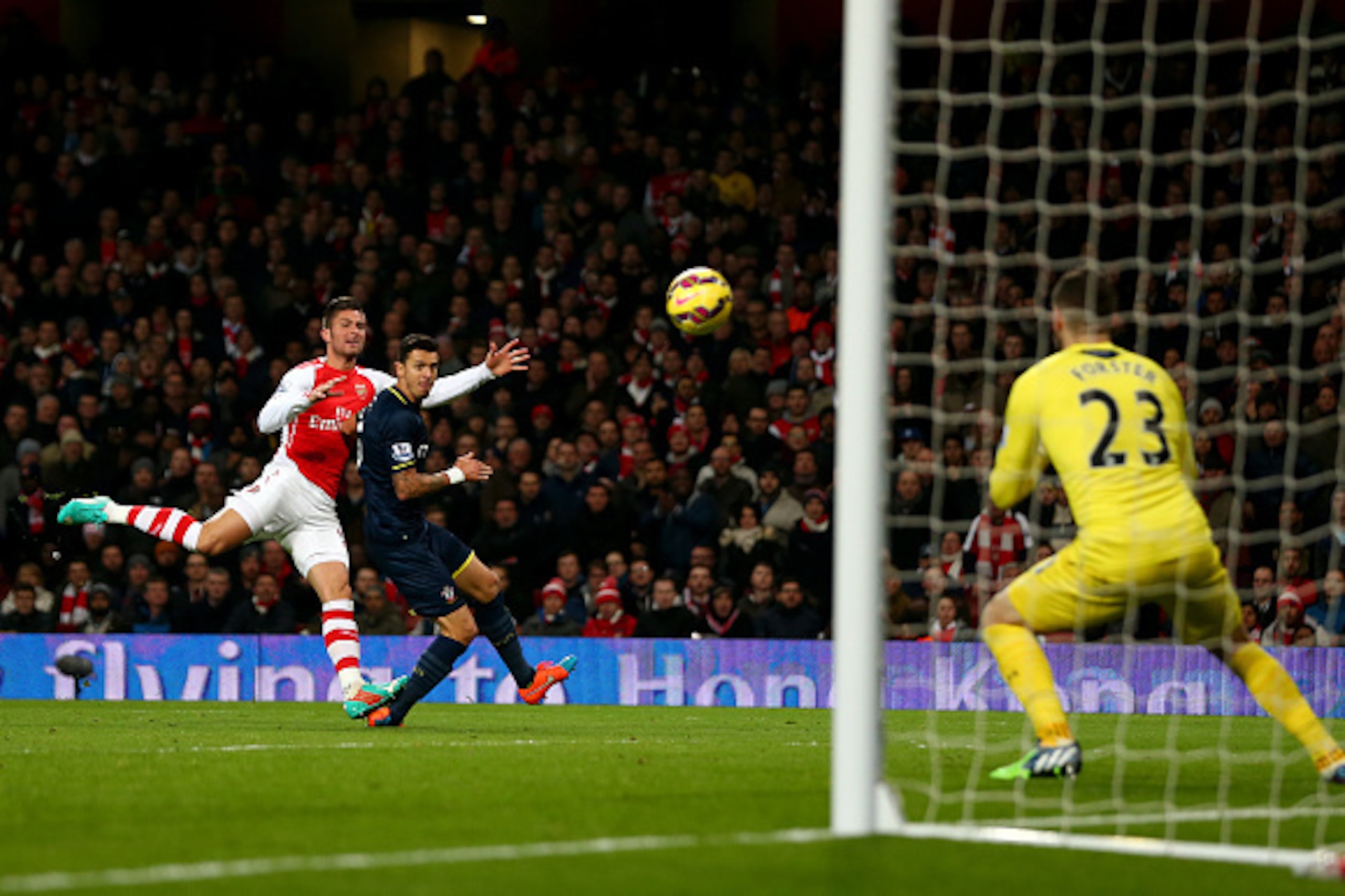 LONDON, ENGLAND - DECEMBER 03:  Olivier Giroud of Arsenal shoots at goal under pressure from Jose Fonte of Southampton during the Barclays Premier League match between Arsenal and Southampton at Emirates Stadium on December 3, 2014 in London, England.  (P
