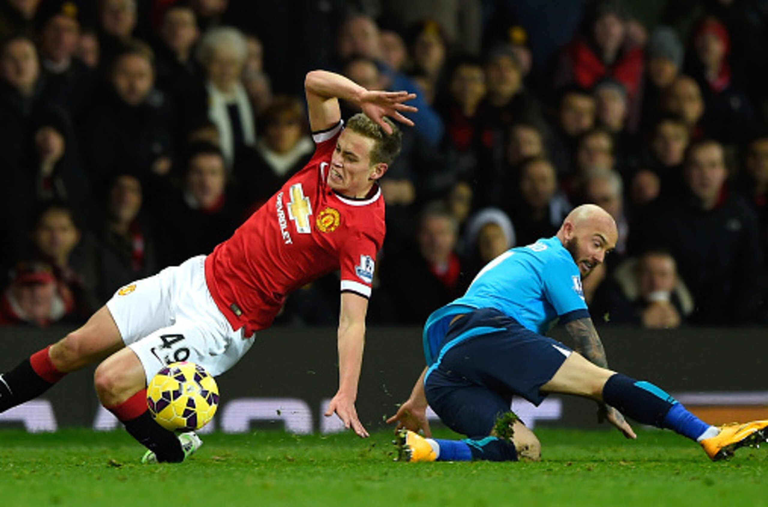 MANCHESTER, ENGLAND - DECEMBER 02:  James Wilson of Manchester United  is challenged by Stephen Ireland of Stoke City during the Barclays Premier League match between Manchester United and Stoke City at Old Trafford on December 2, 2014 in Manchester, Engl